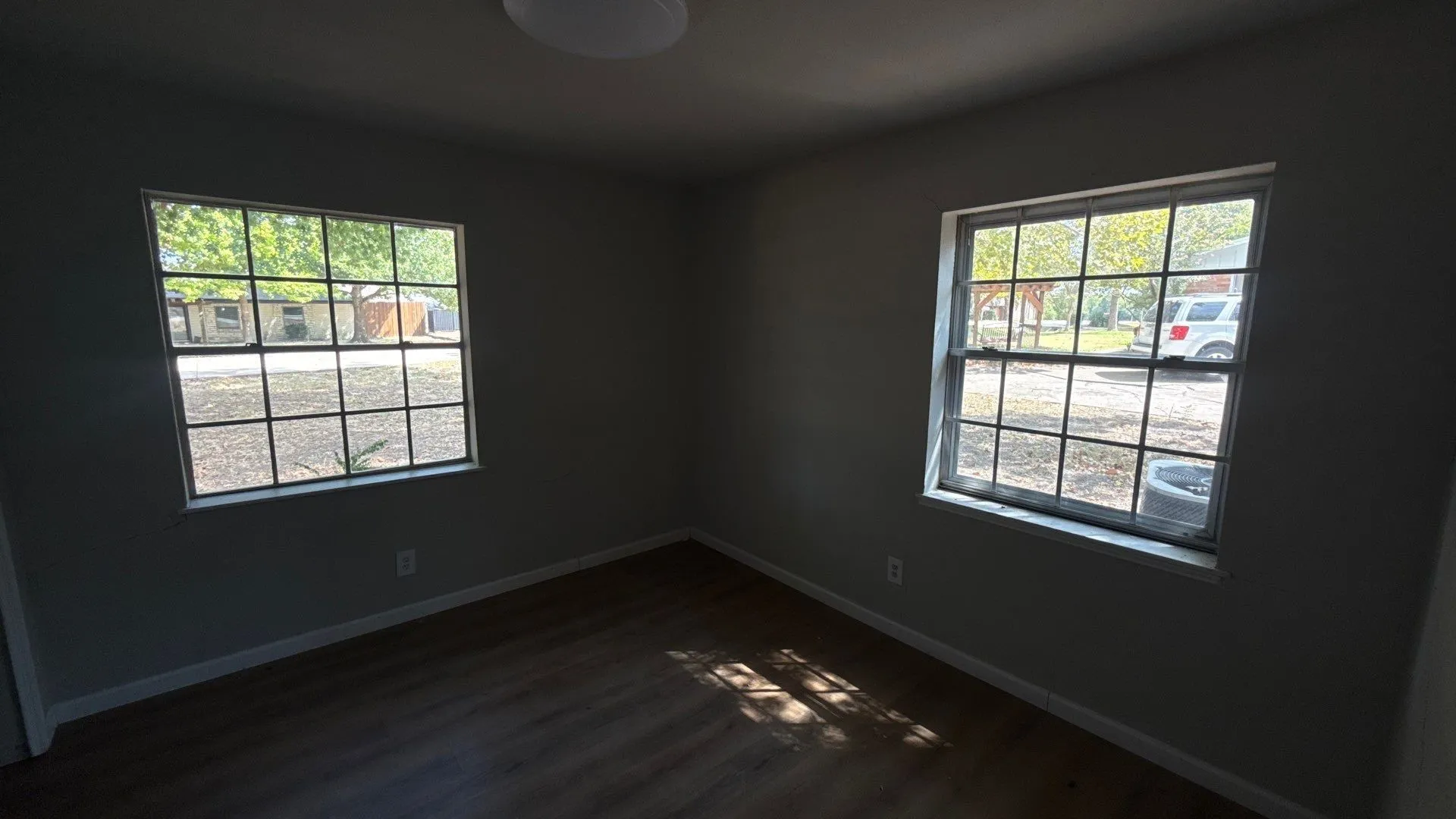 Neutral wall color, wood-finish flooring, and white trim