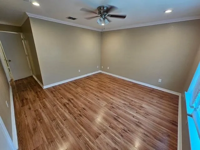 Unfurnished room with ceiling fan, wood finished floors, crown molding, and recessed lighting