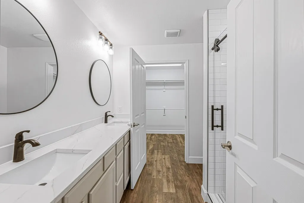 Renovated bathroom with new tiled, walk-in shower, new toilet, quartz countertop, updated lighting and faucets