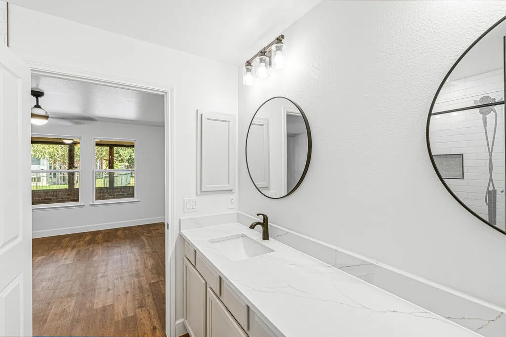 Renovated bathroom with new tiled, walk-in shower, new toilet, quartz countertop, updated lighting and faucets
