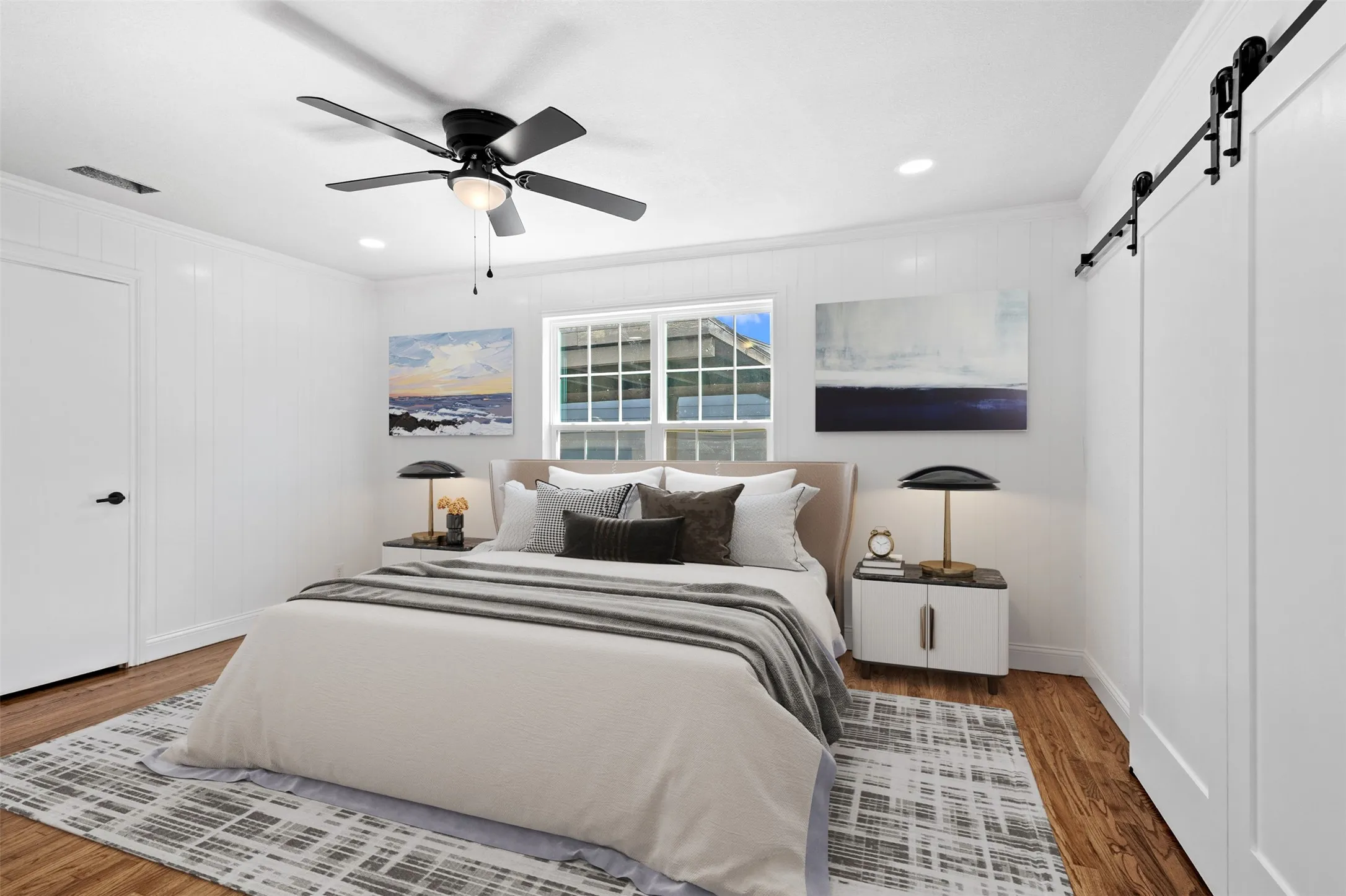 Wood-finish flooring, white panel walls, and a multi-pane window
