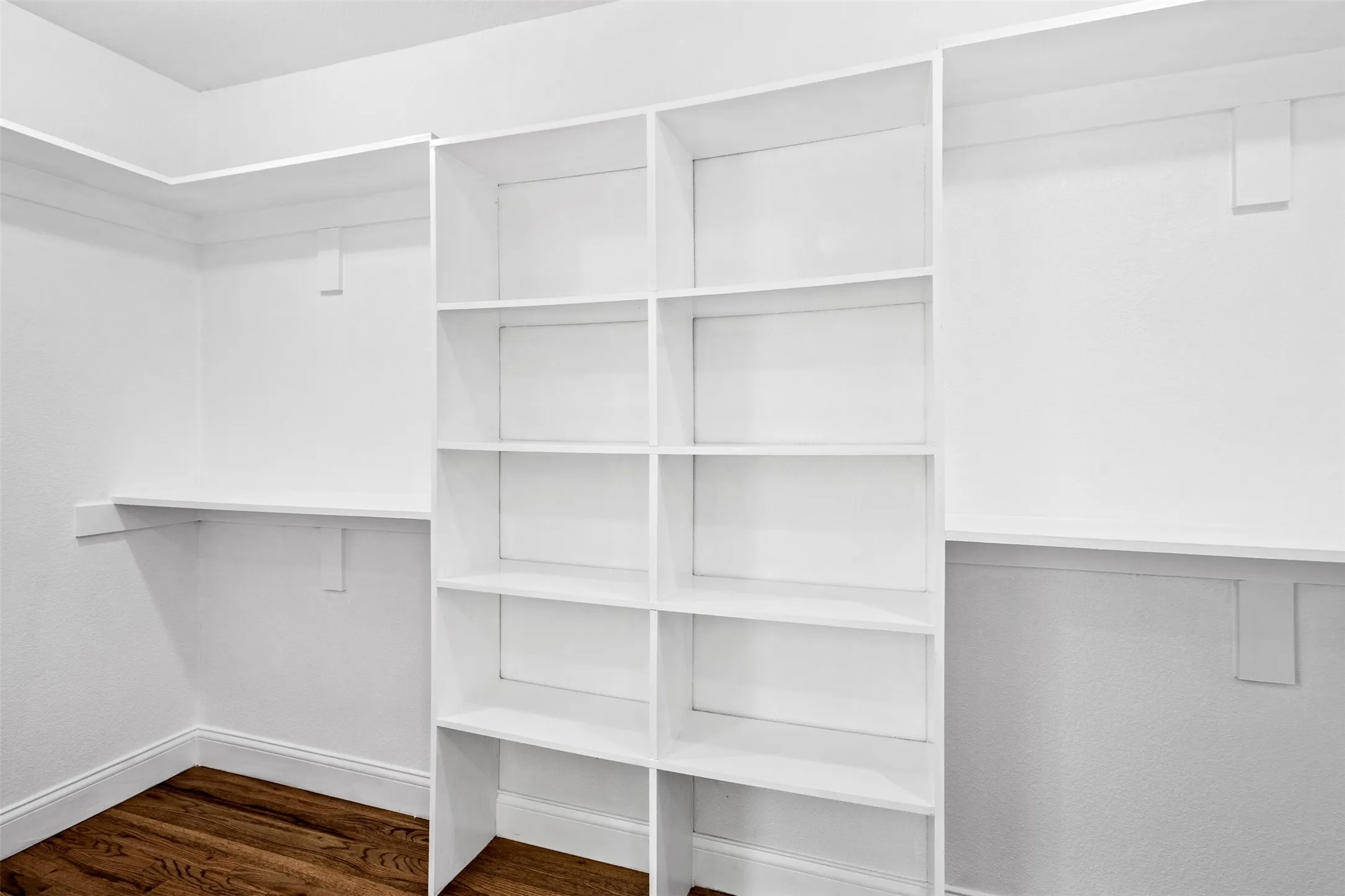 Built-in shelving and storage, crisp white finishes, rich wood-finish flooring