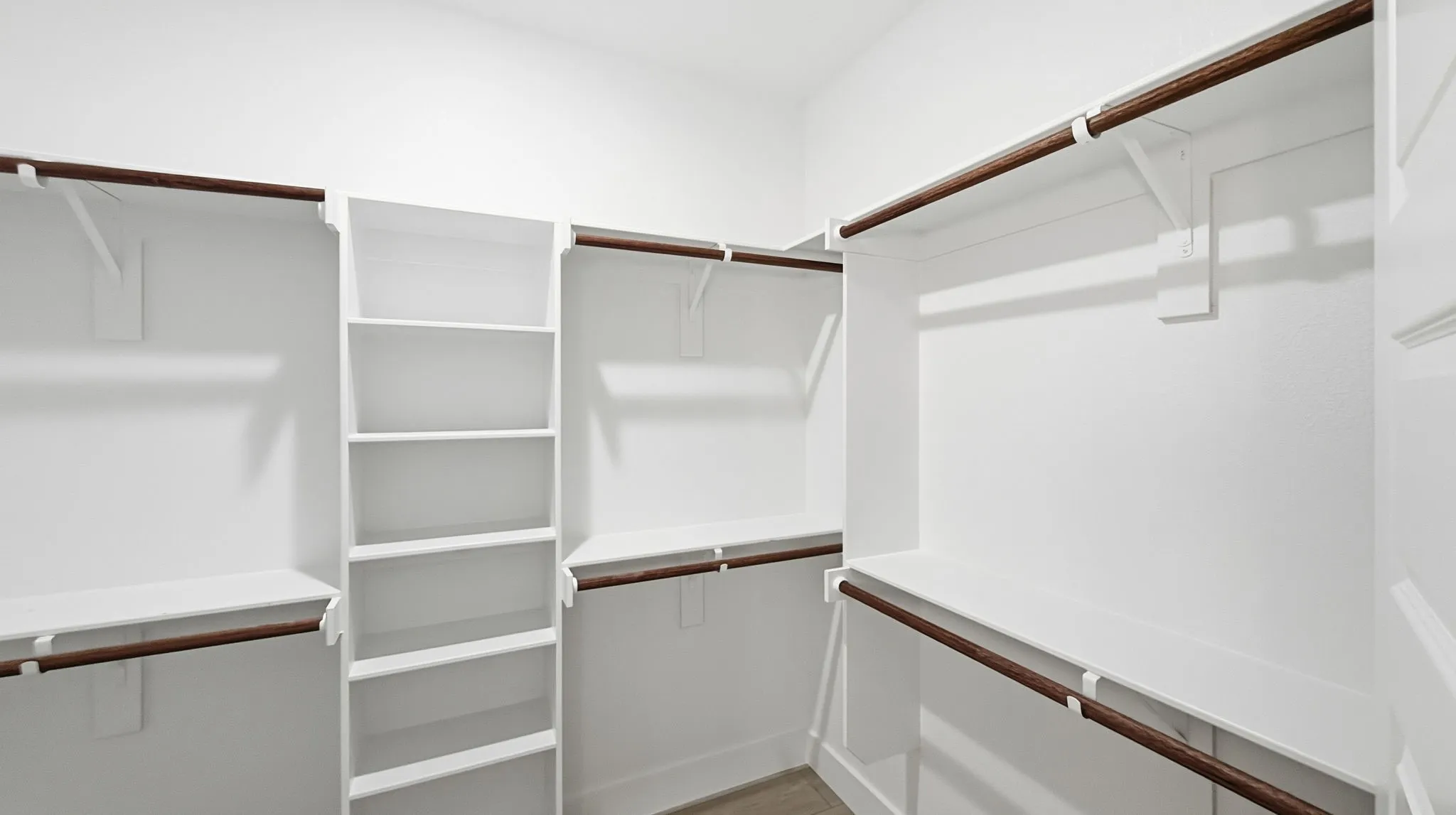 Primary closet located in the primary bathroom