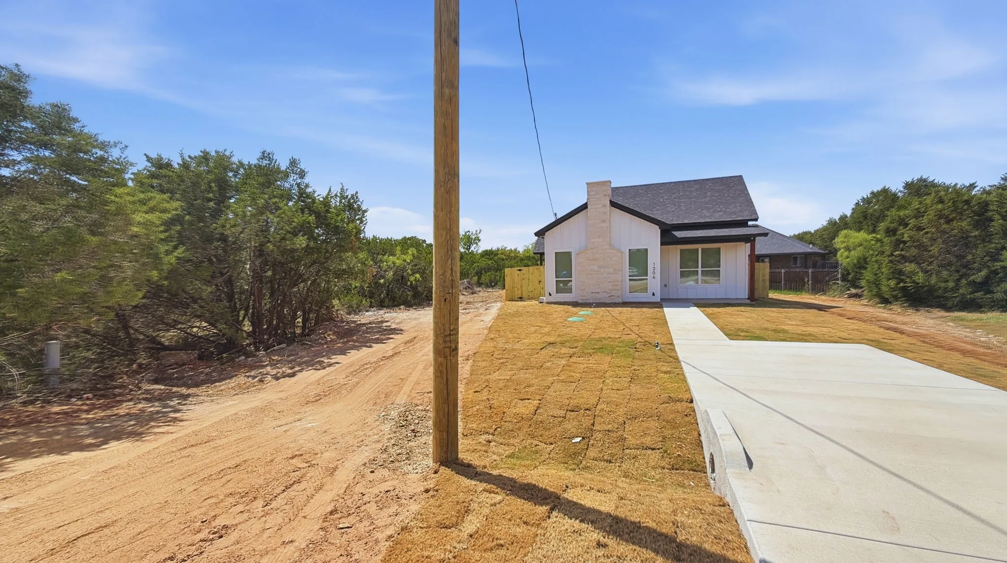 Front view and concrete driveway of new home