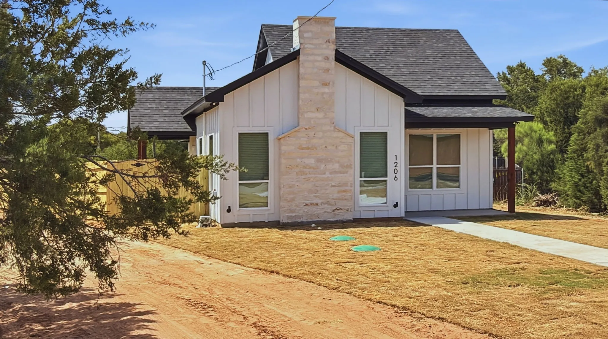 Full concrete driveway and sidewalk to entry