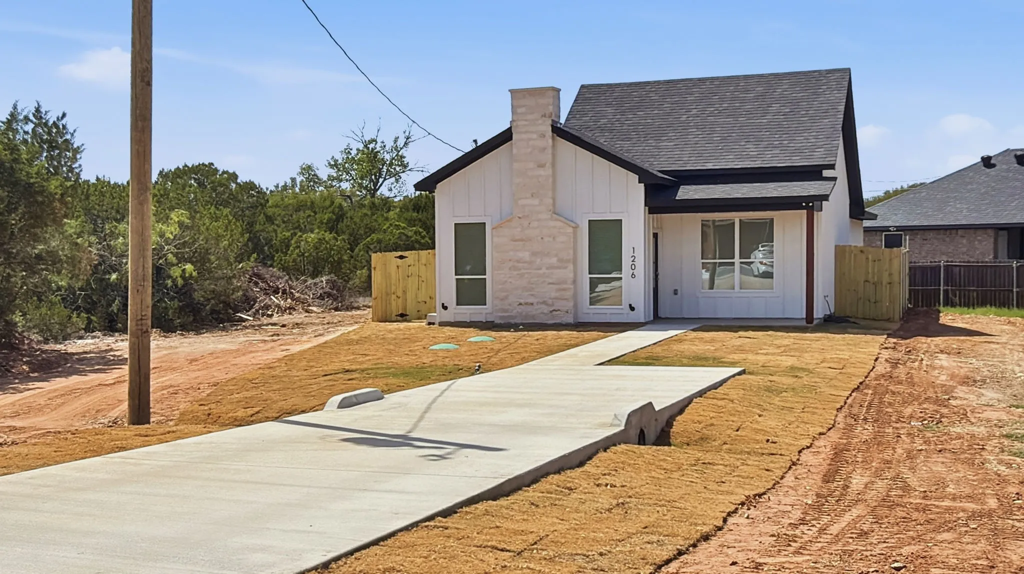 Full sod, covered front porch, elegant stone