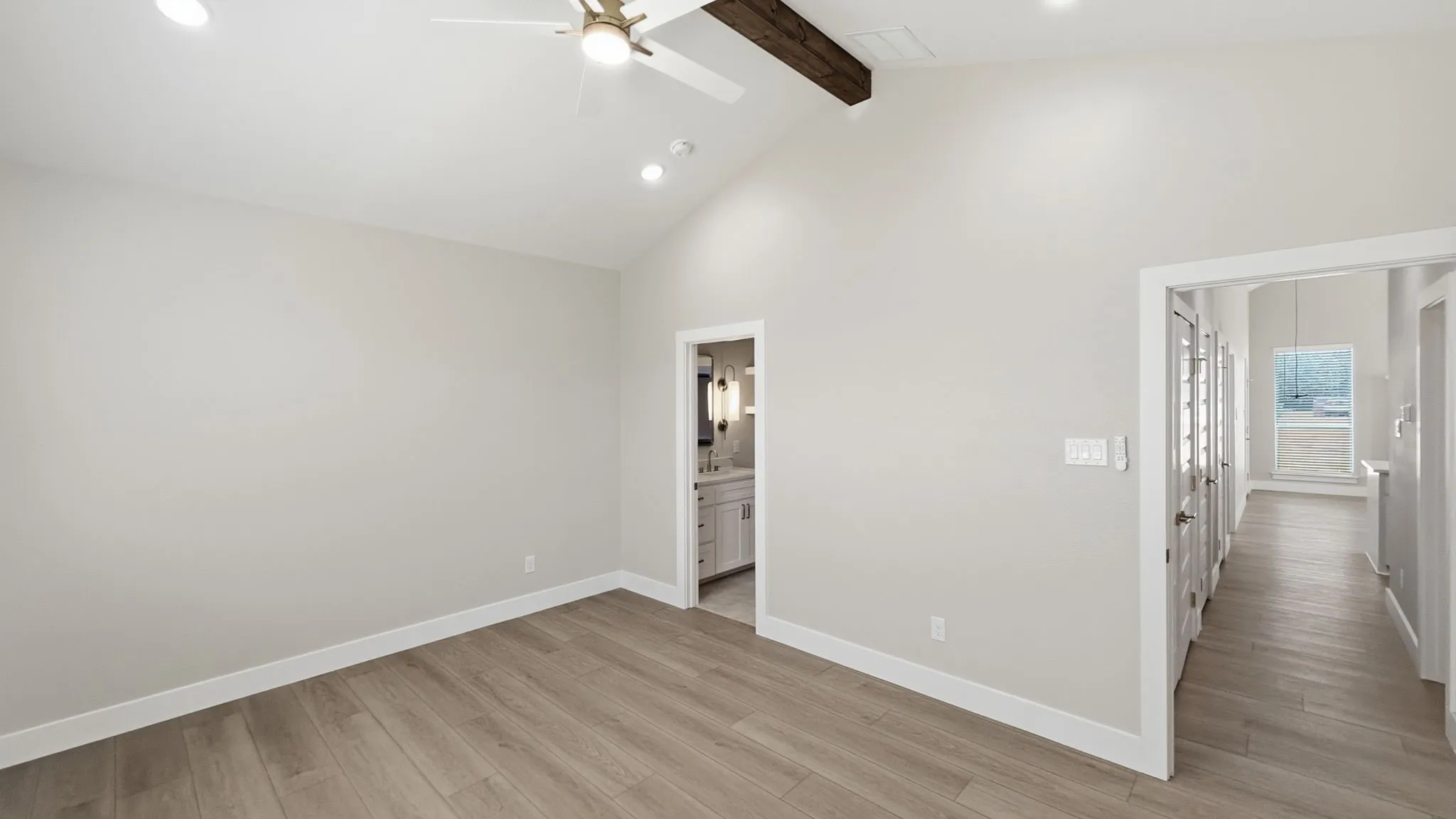 Primary bedroom with hallway to the right