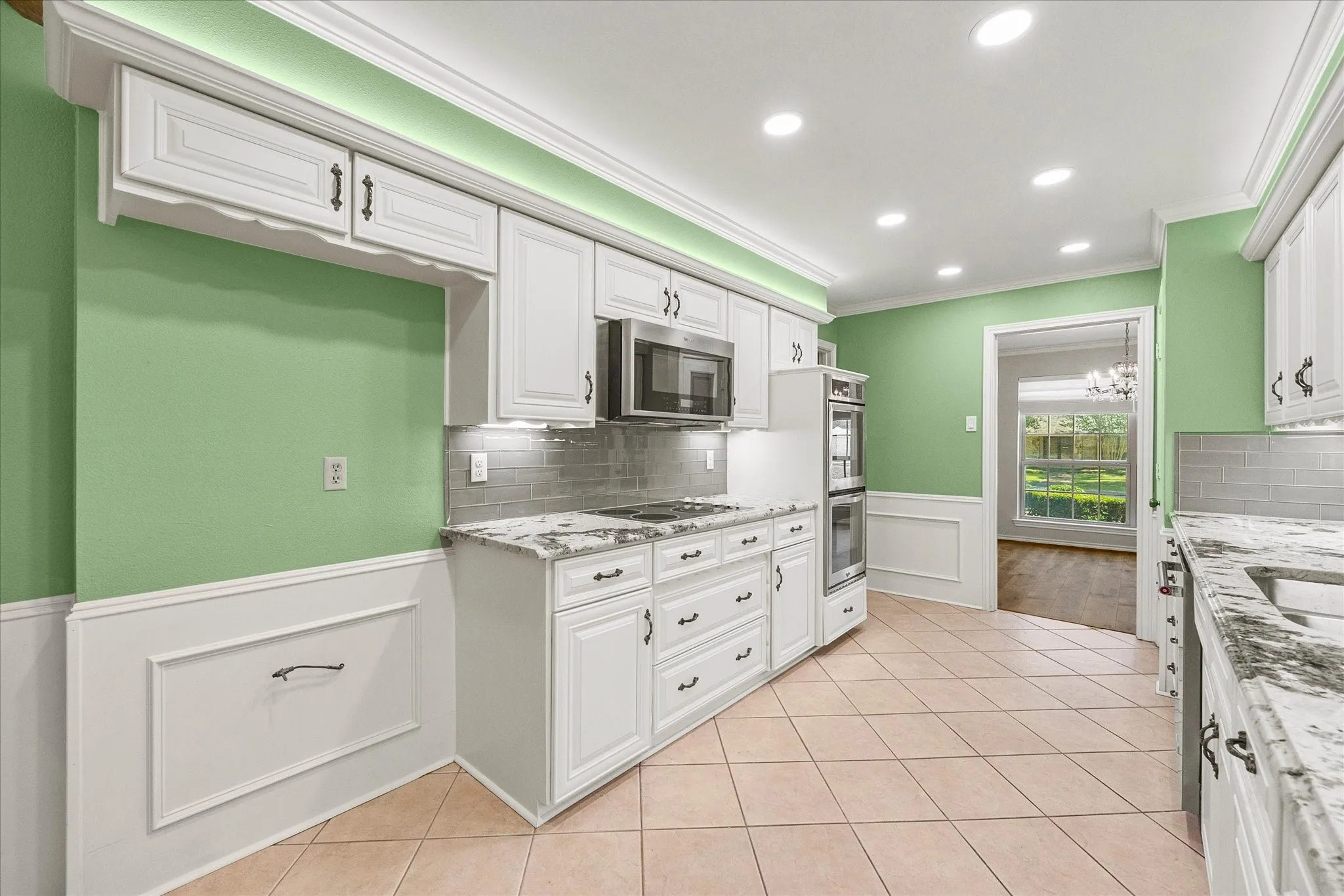 Updated appliances including double oven, dishwasher, and microwave. Electrical stove top is plumbed for gas.