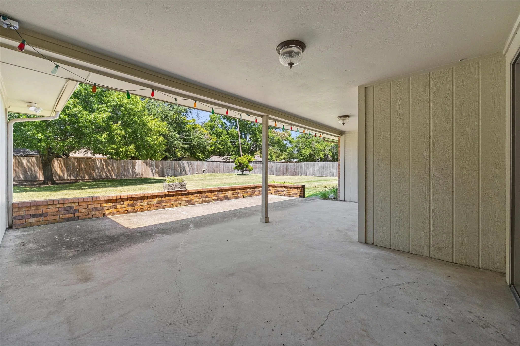 Covered patio overlooking the spacious backyard.