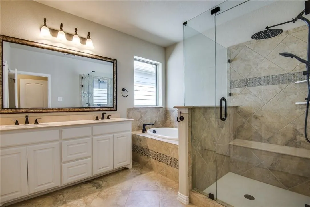 Dual sink vanity with white cabinetry and dark bronze fixtures