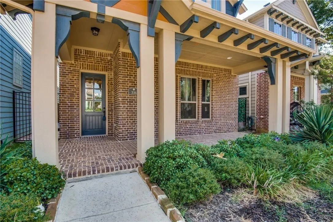 Brick exterior with a covered porch featuring decorative corbels