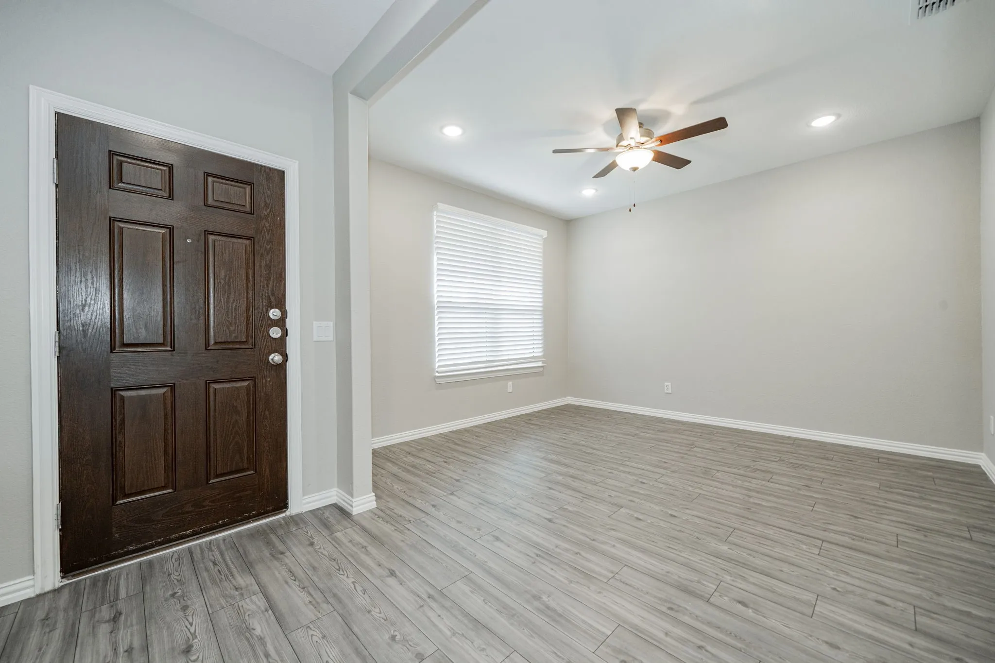 Wood-finish flooring throughout, recessed lighting, and a ceiling fan with light fixture