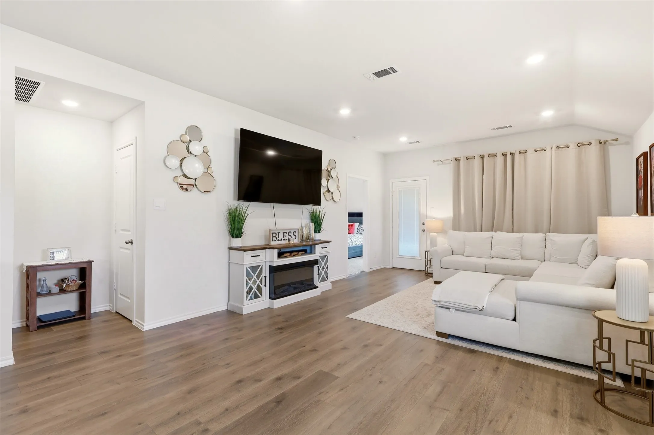 Recessed lighting, wood-finish flooring, white walls