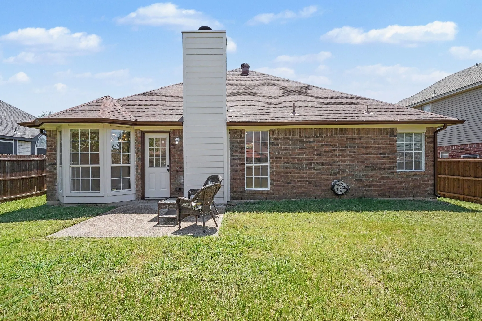 Brick exterior with a gabled roof and bay window