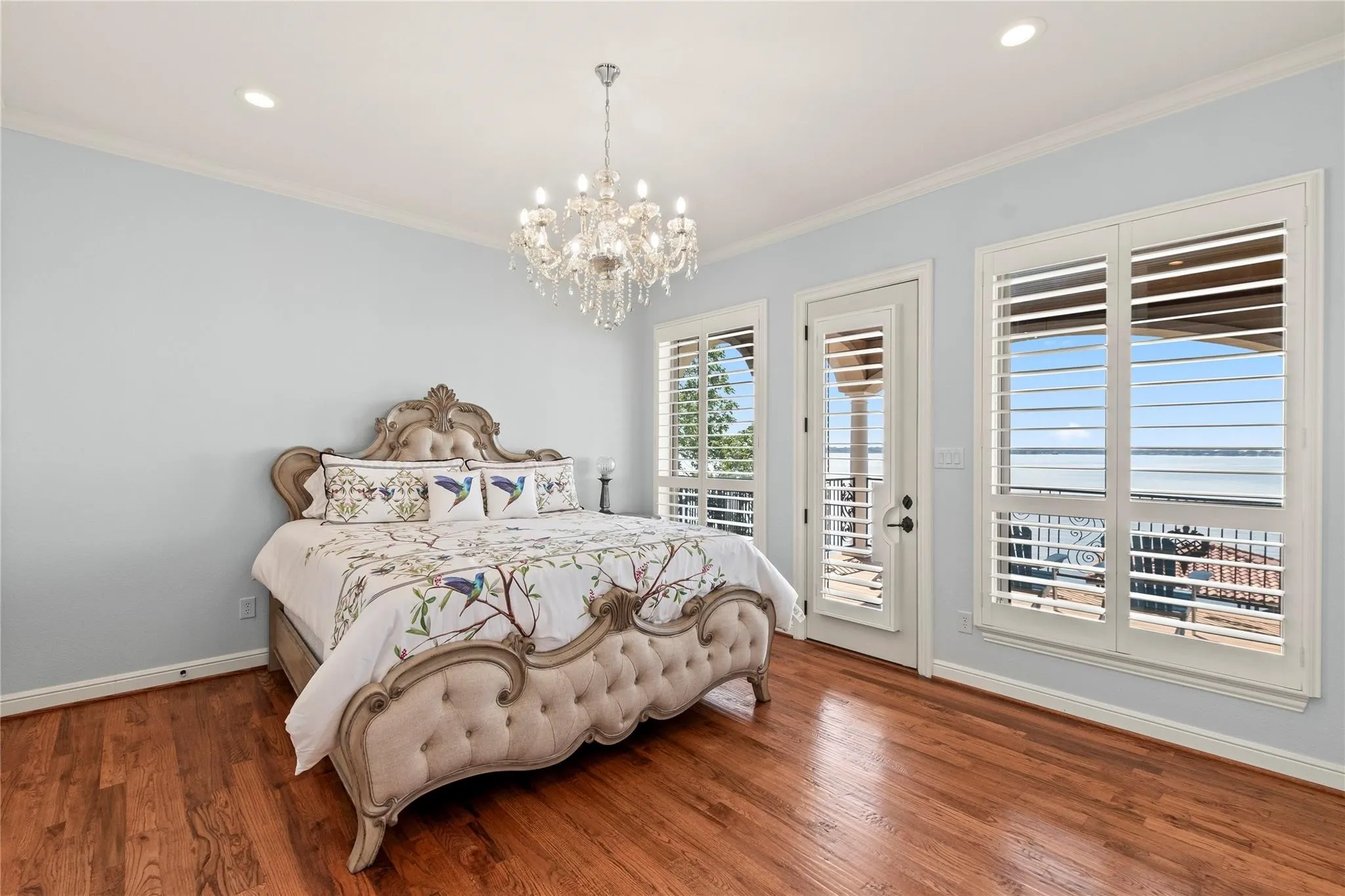 Upstairs waterside guest retreat with private living area, ensuite bath, huge walk-in closet, and balcony access.