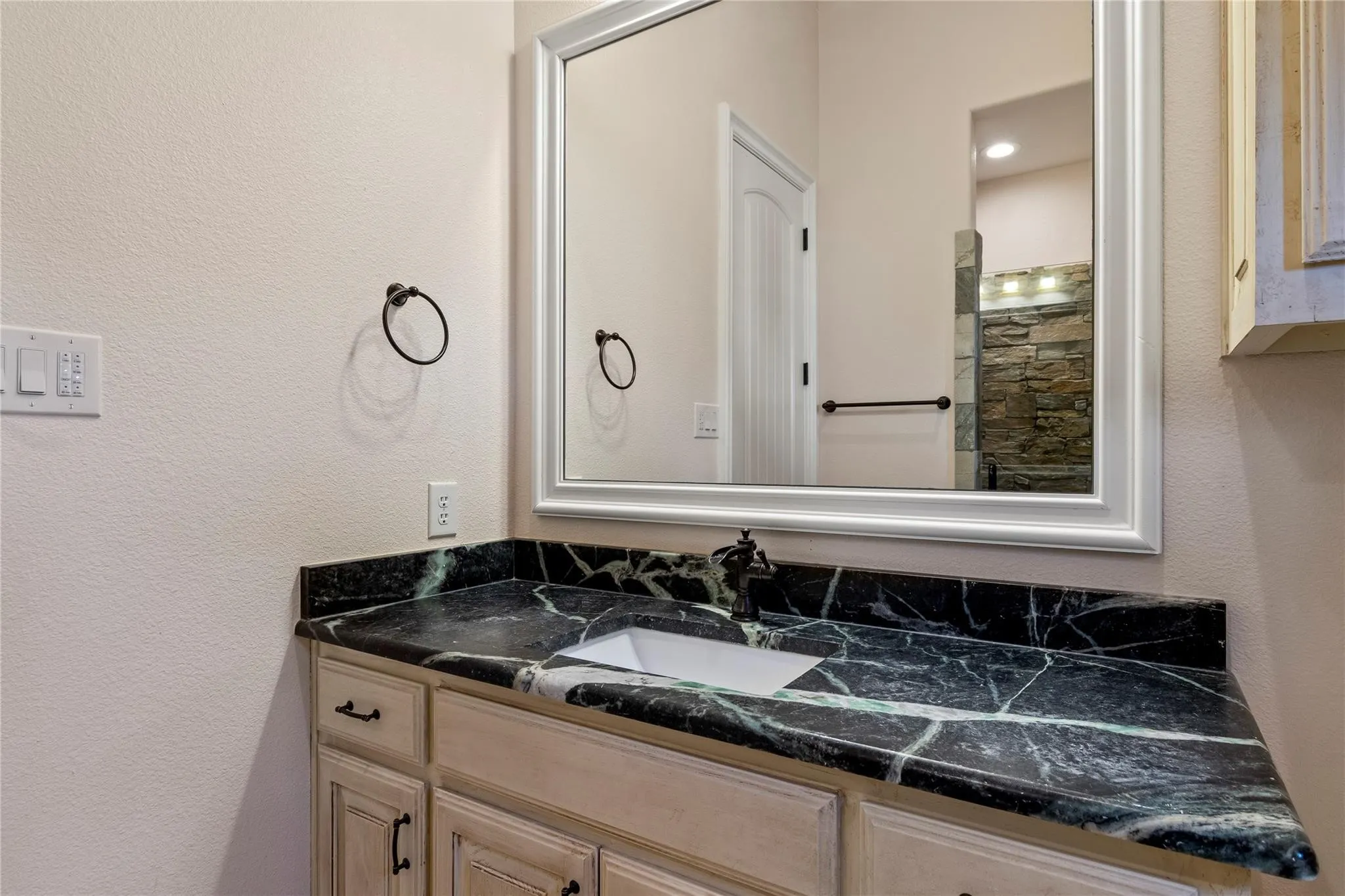 
Third full bathroom on the main floor with stone walk in shower and outdoor access from side of house.
