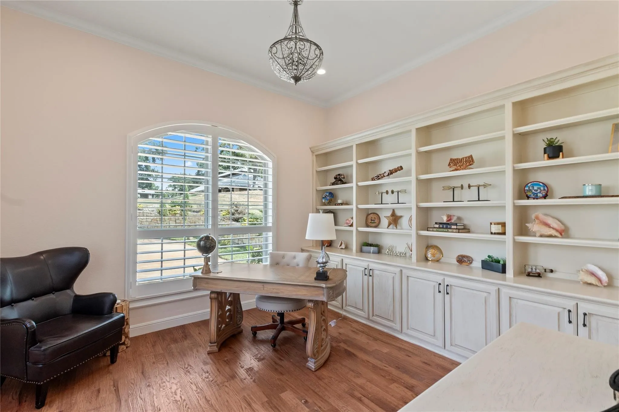 Tucked-away office space with built ins offers privacy for work or study with full bath next to it.