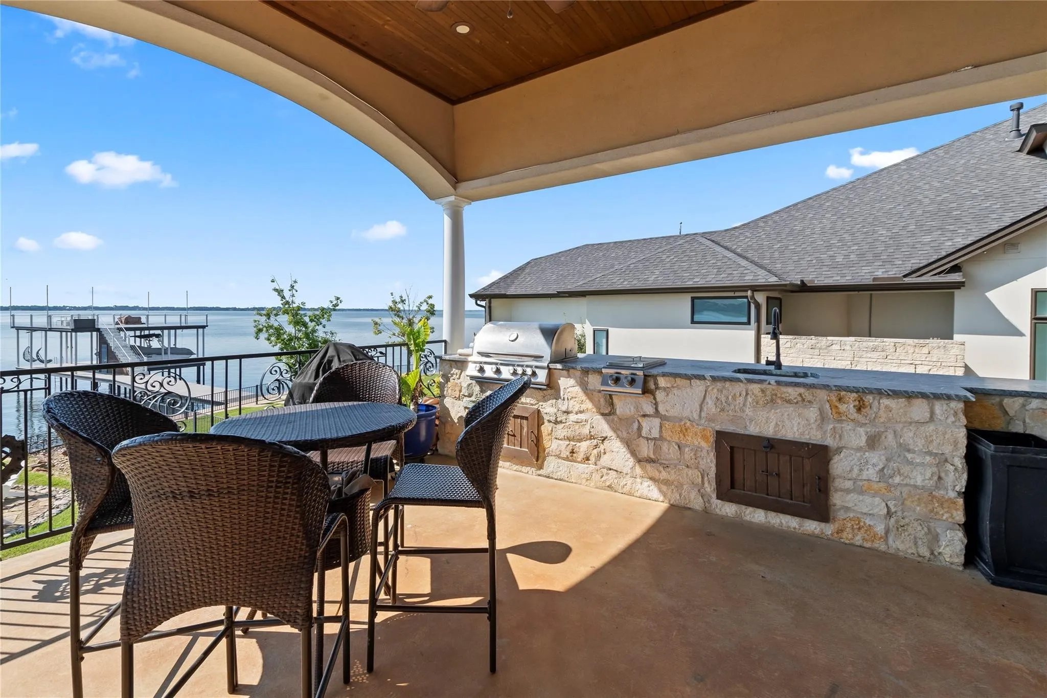 Outdoor kitchen with built-in griddle and sink for lakeside entertaining.