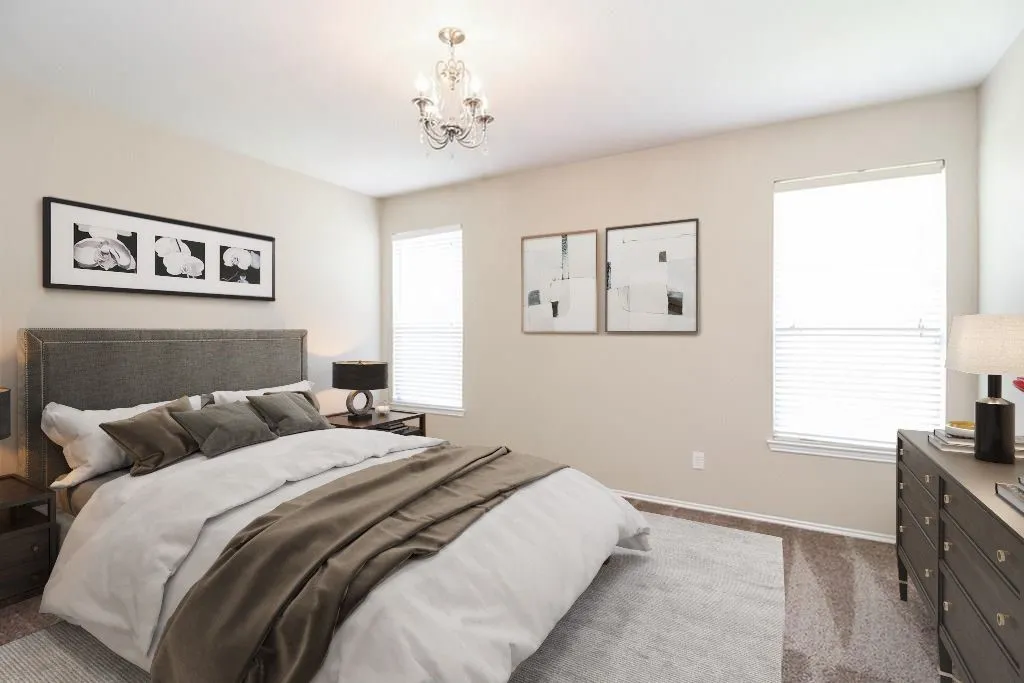 Recessed lighting, chandelier, two windows with blinds, and carpeted flooring
