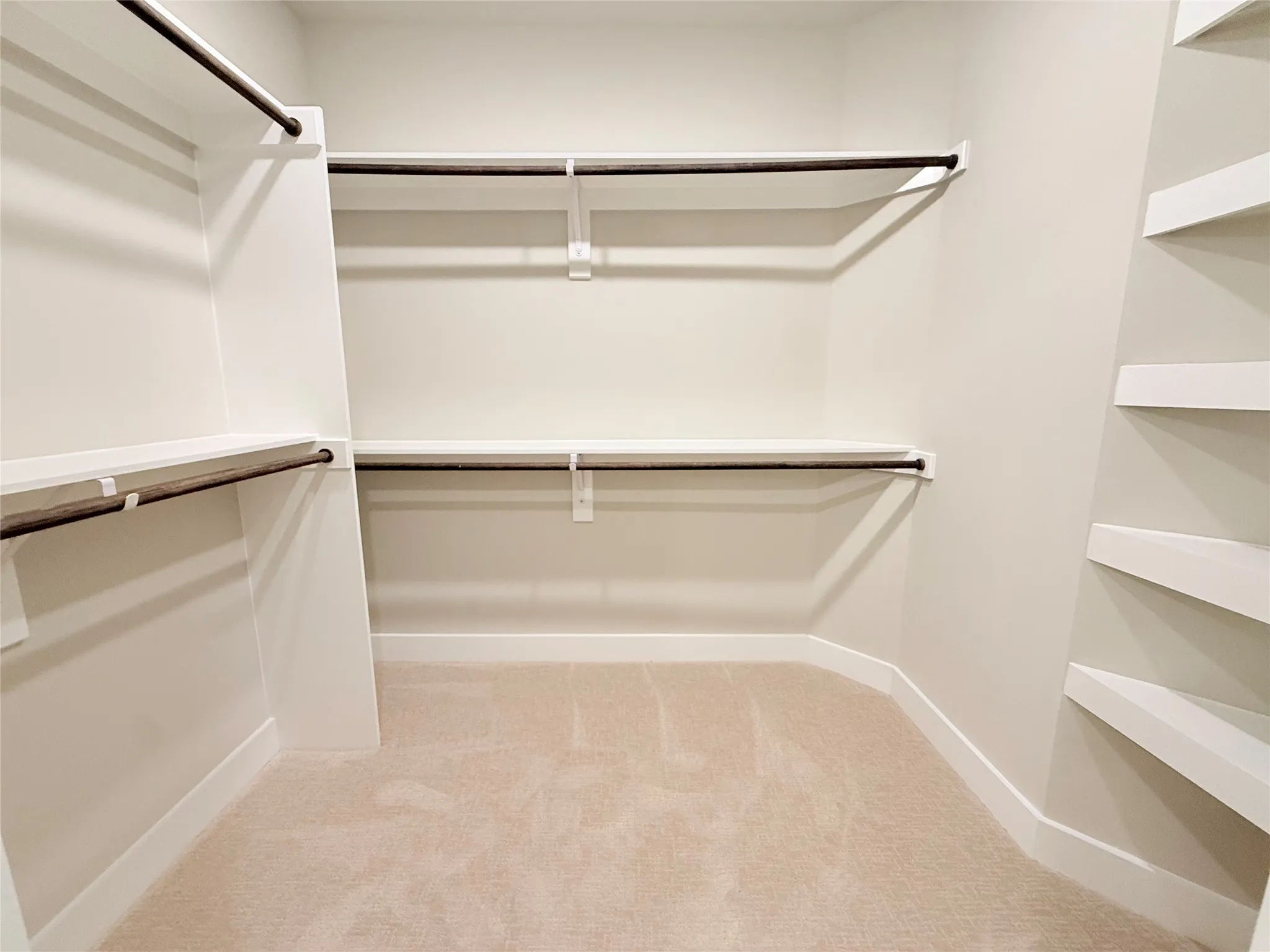 Walk in closet featuring light carpet
