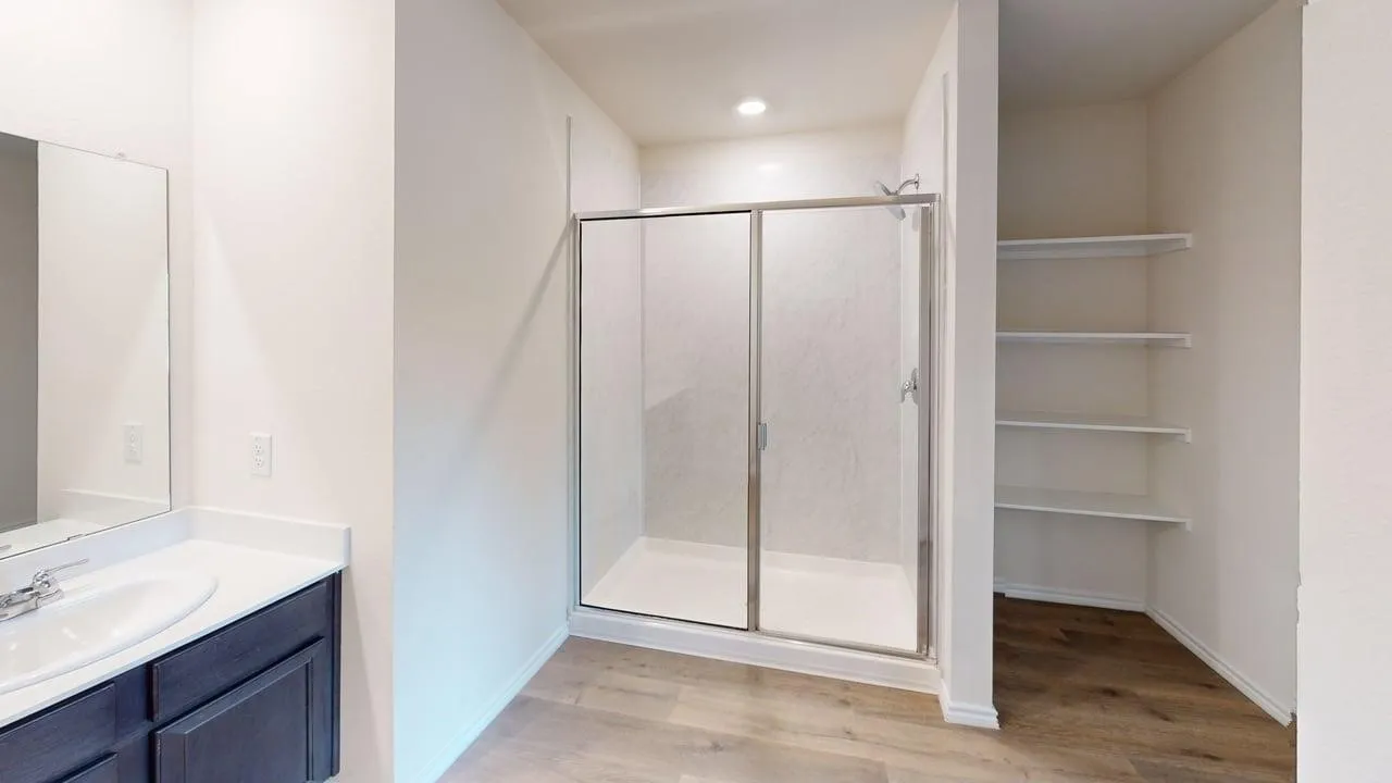 Vanity with a single sink, an integrated countertop, and dark wood-finish cabinetry