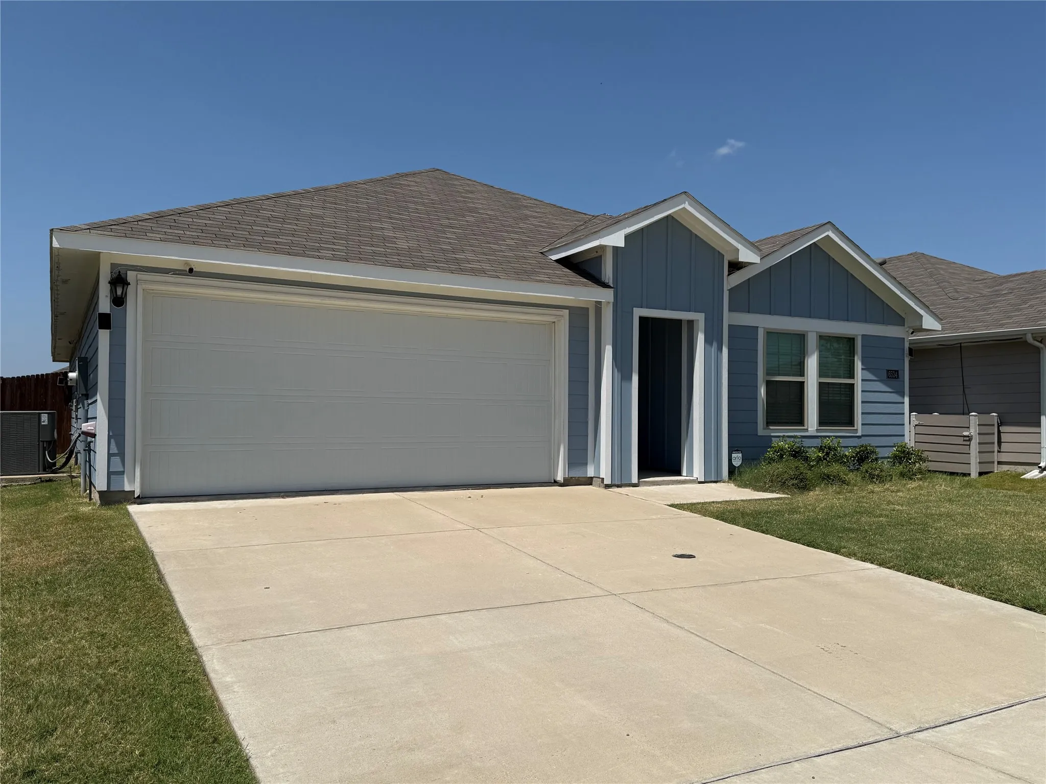 Light blue siding exterior with a two-car garage