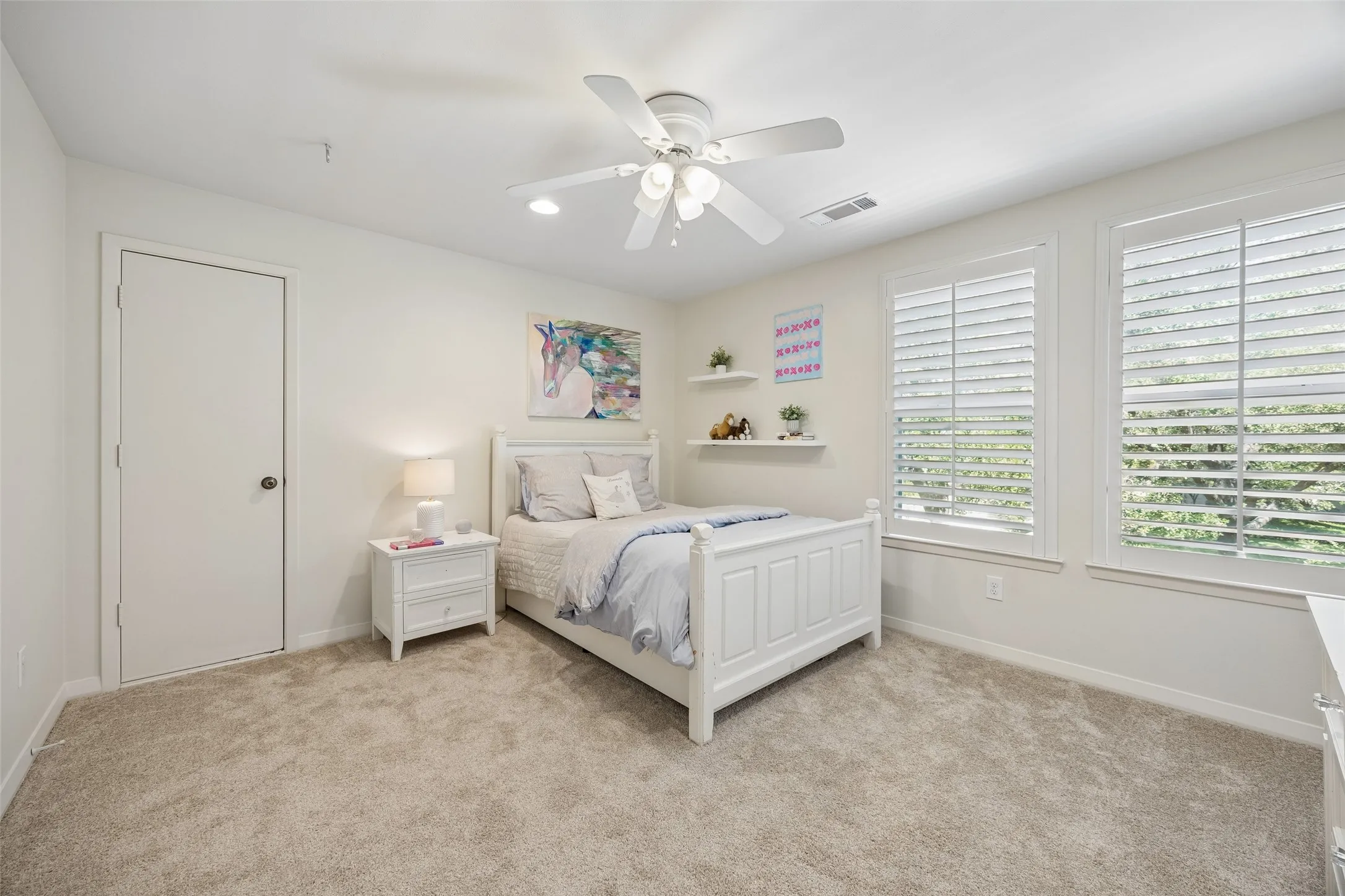 A spacious upstairs guest bedroom with abundant natural light, a walk-in closet, and access to a Jack-and-Jill bath.