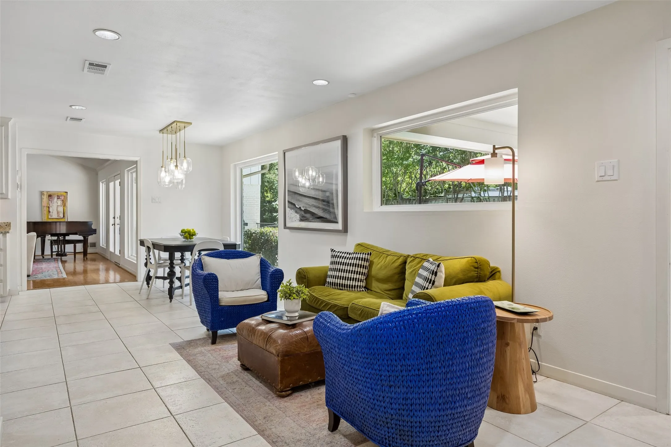 A light-filled casual living and dining area offers an easy connection to the kitchen and views of the​​‌​​​​‌​​‌‌​‌‌​​​‌‌​‌​‌​‌​​​‌​​ backyard.