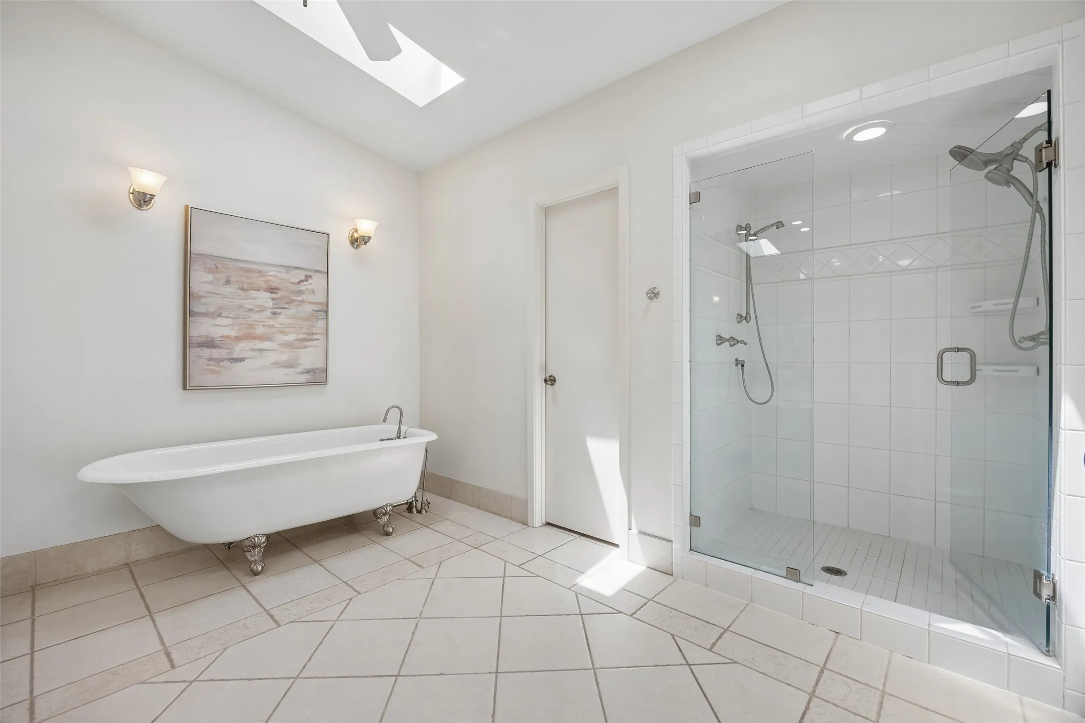 A second view of the primary bath highlights the spacious walk-in shower, dual shower heads and private water closet.