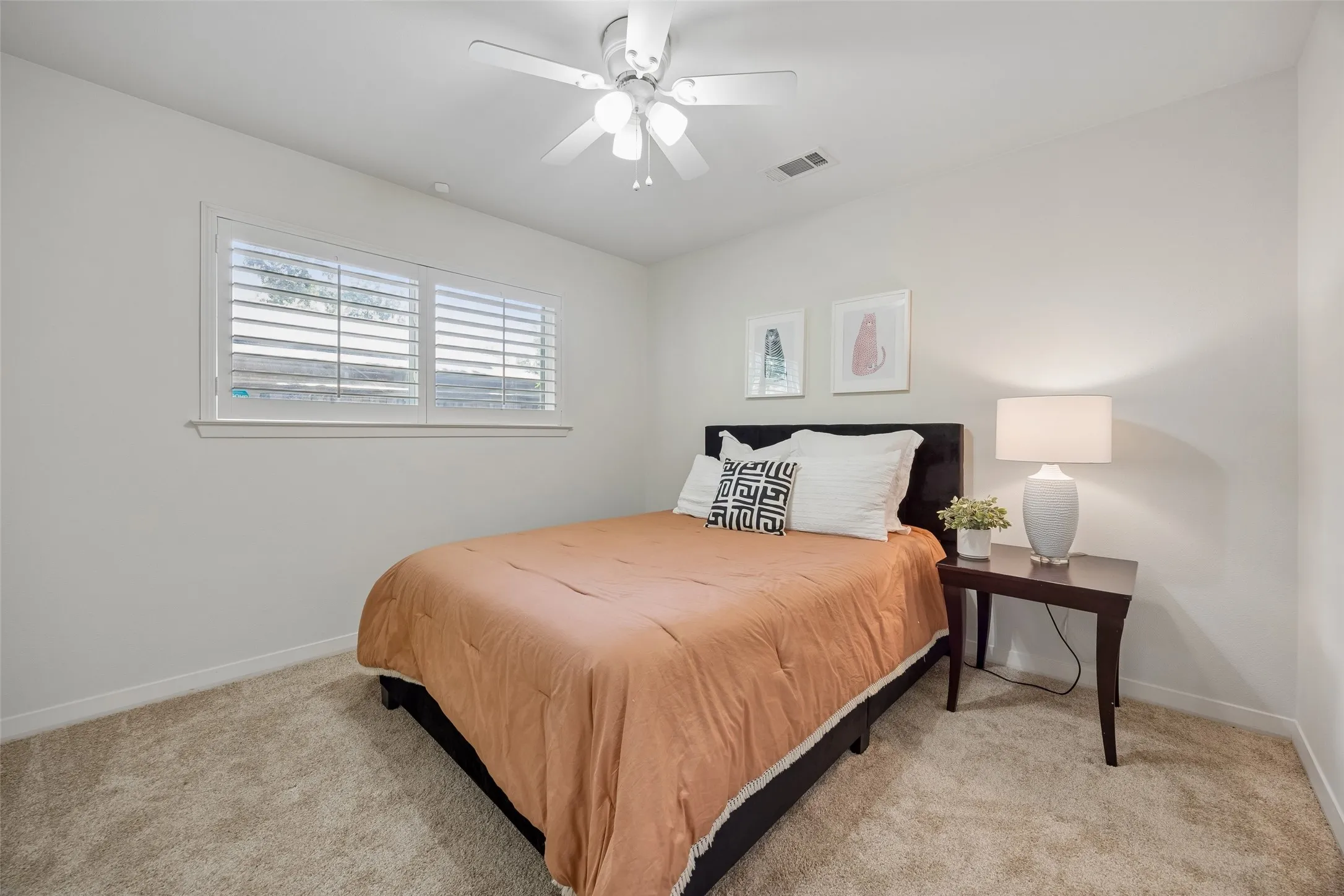 A spacious downstairs bedroom with abundant natural light and private access to a Jack-and-Jill bath.