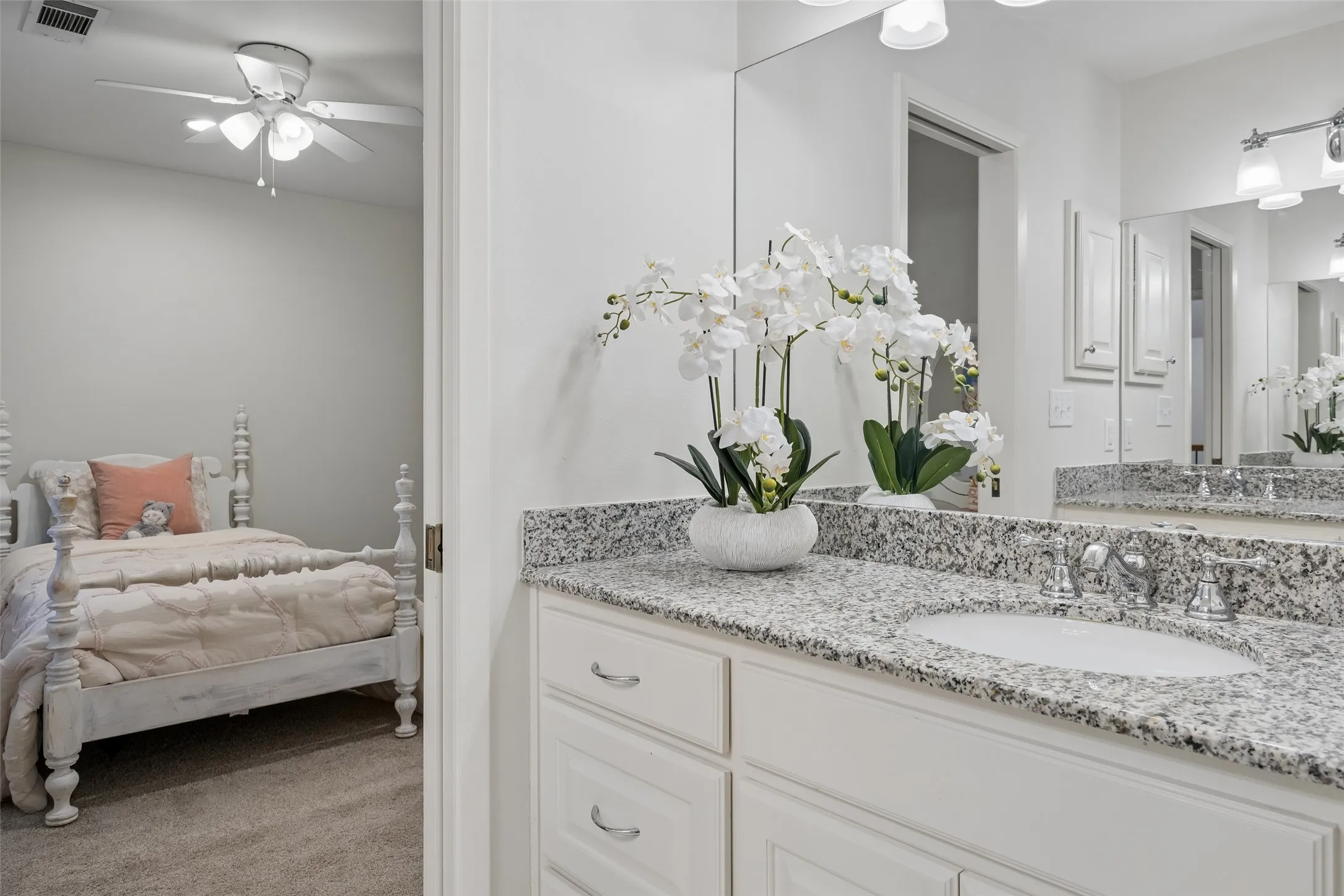 An upstairs Jack-and-Jill bath features two granite-topped vanity and convenient access to the adjoining bedrooms.