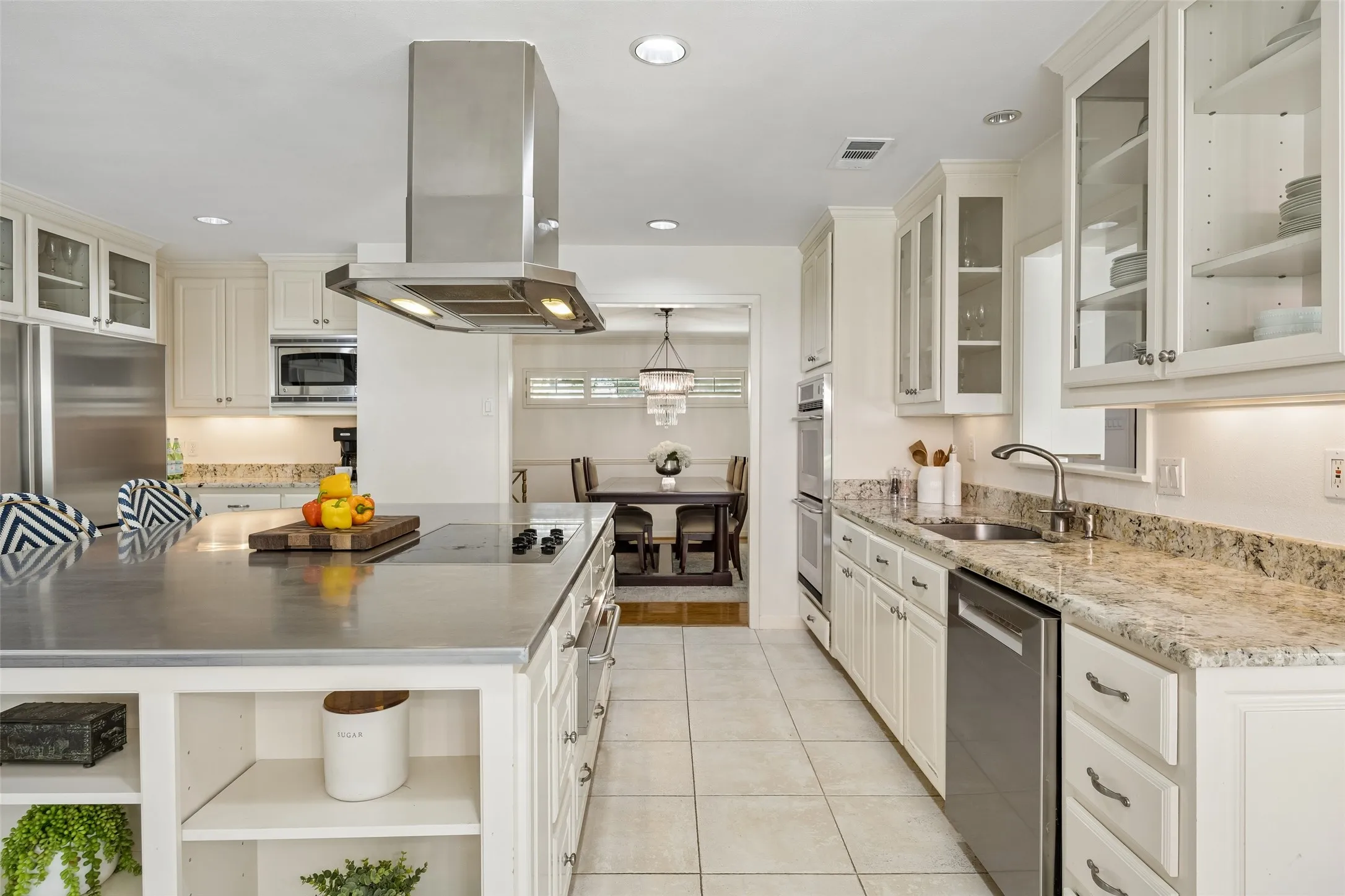 Another view of the kitchen highlights abundant cabinetry, generous counter space, stainless steel appliances, and a functional layout designed for everyday living.