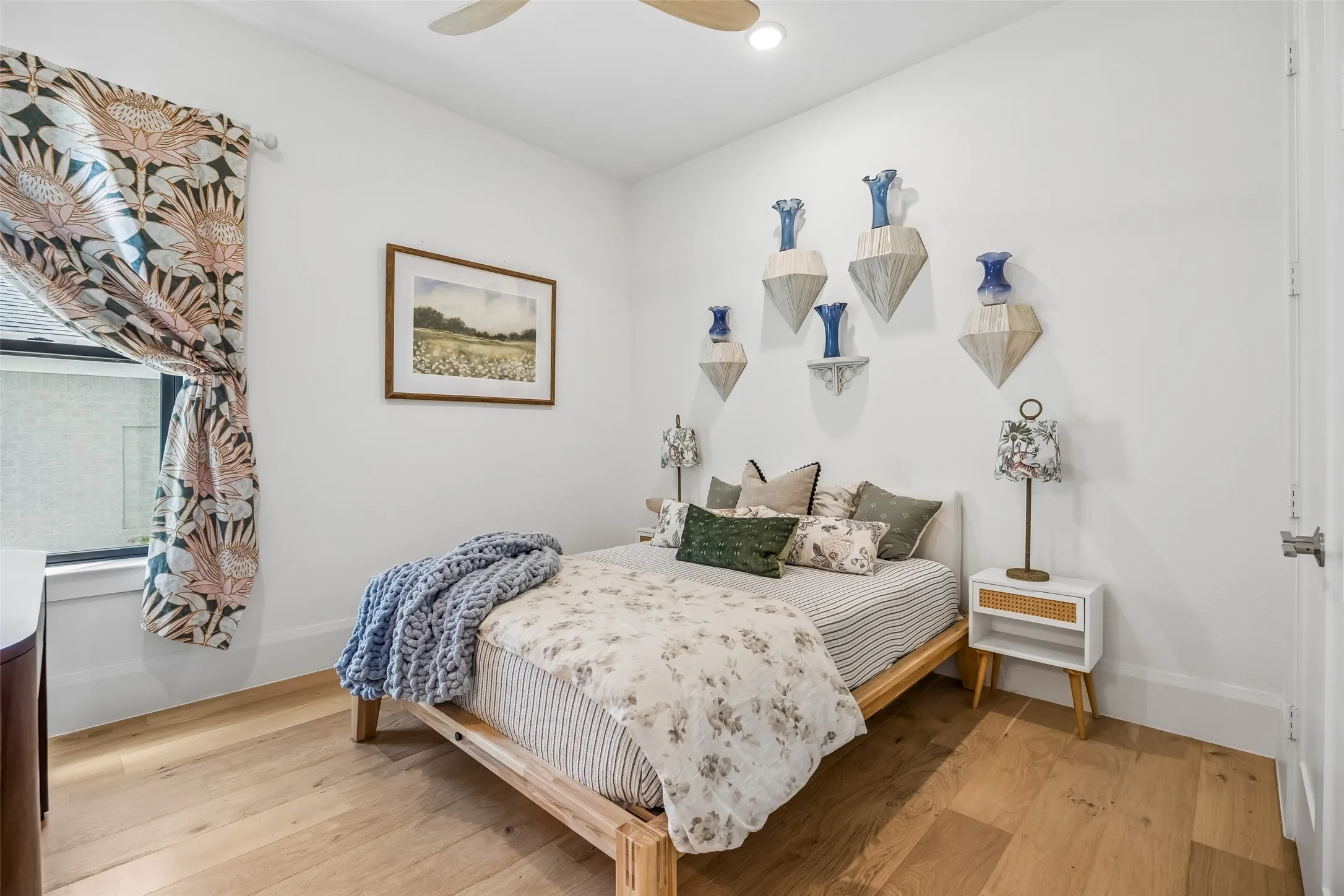 A thoughtfully designed downstairs guest suite features wood floors, abundant natural light, stylish designer details and a private en suite bath.
