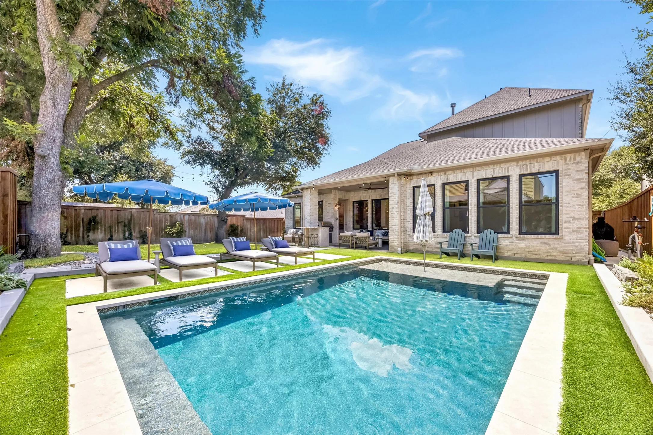 A resort-like backyard offers a sparkling pool, generous patio space and mature landscaping, creating an inviting setting for outdoor living and entertaining.