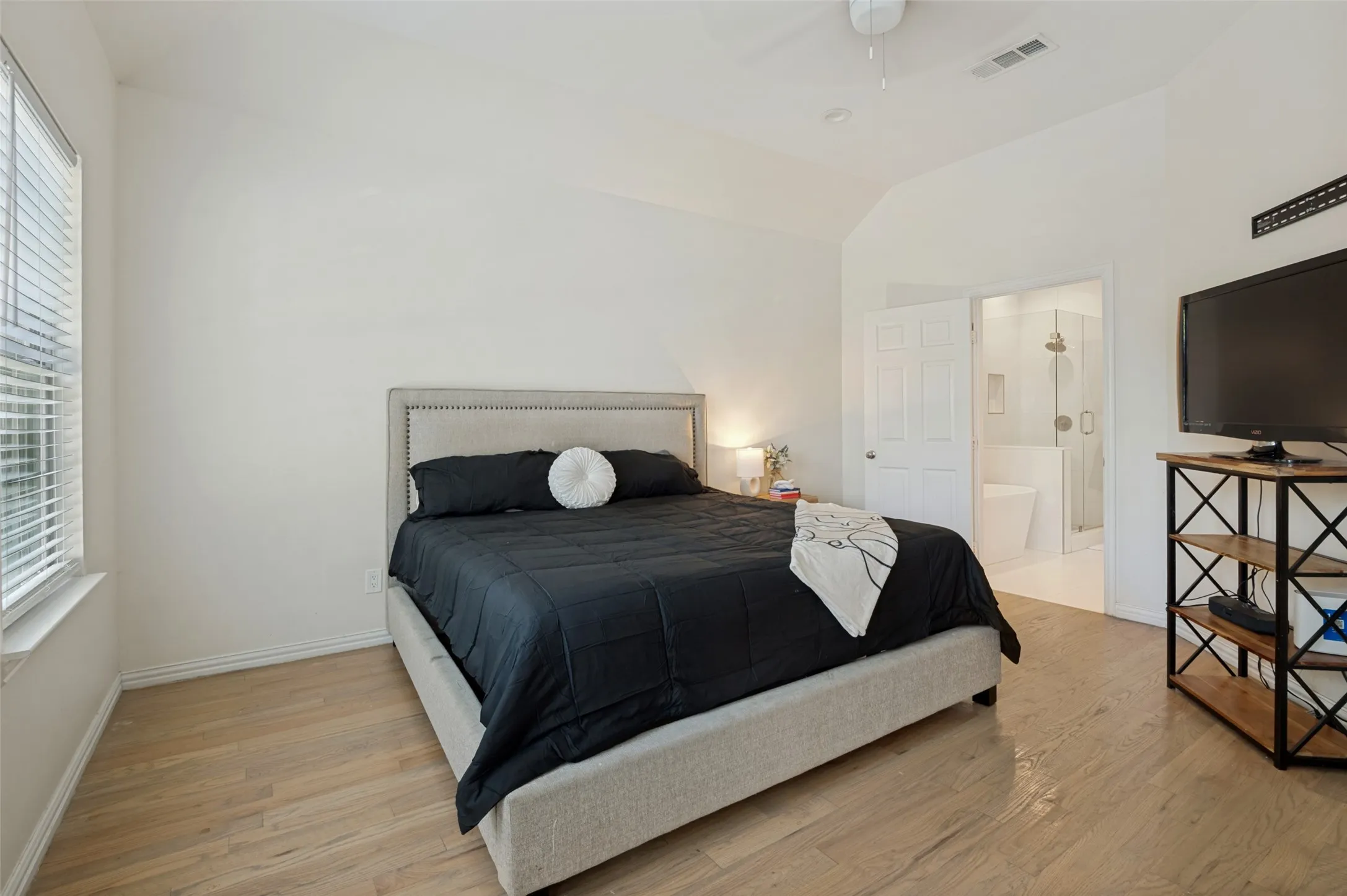 Light and bright master bedroom that leads to the spacious master bath