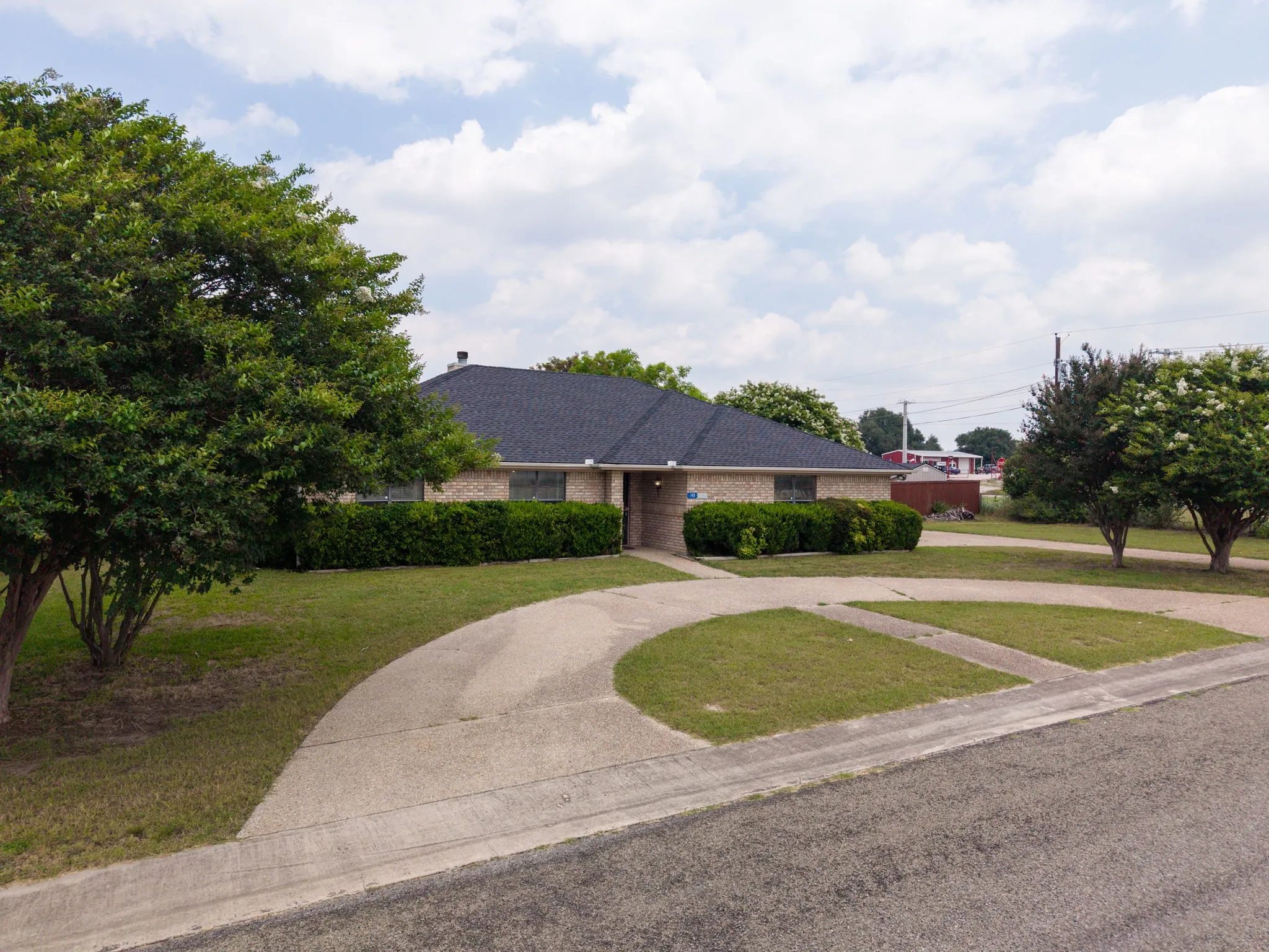 Brick exterior with a dark-shingled roof