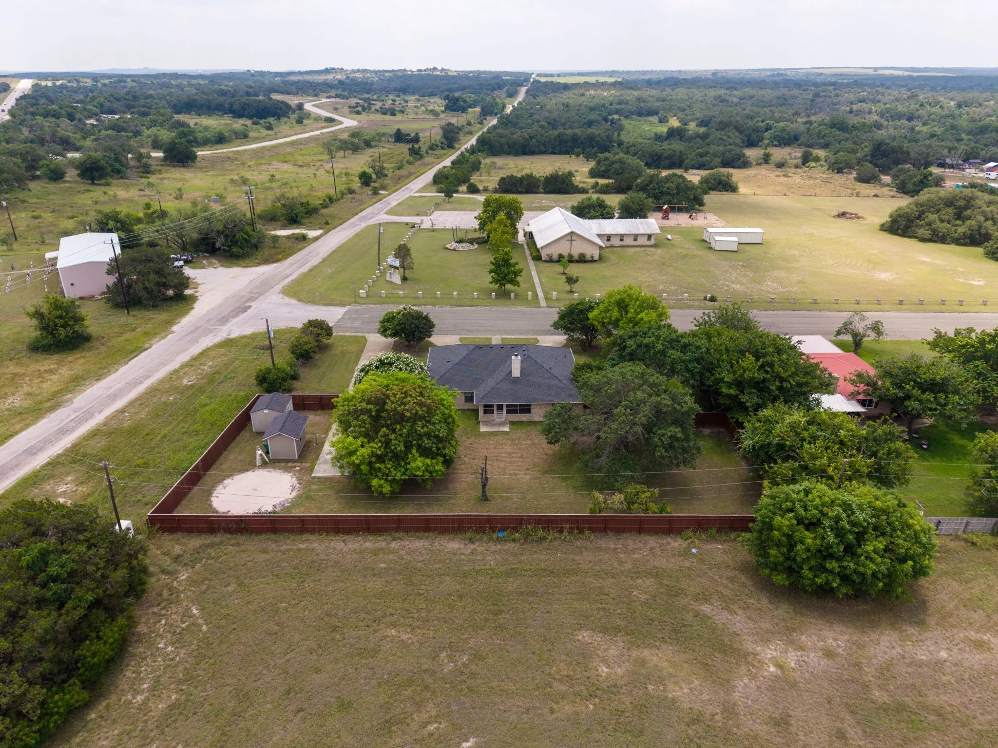 Fenced perimeter with multiple mature trees
