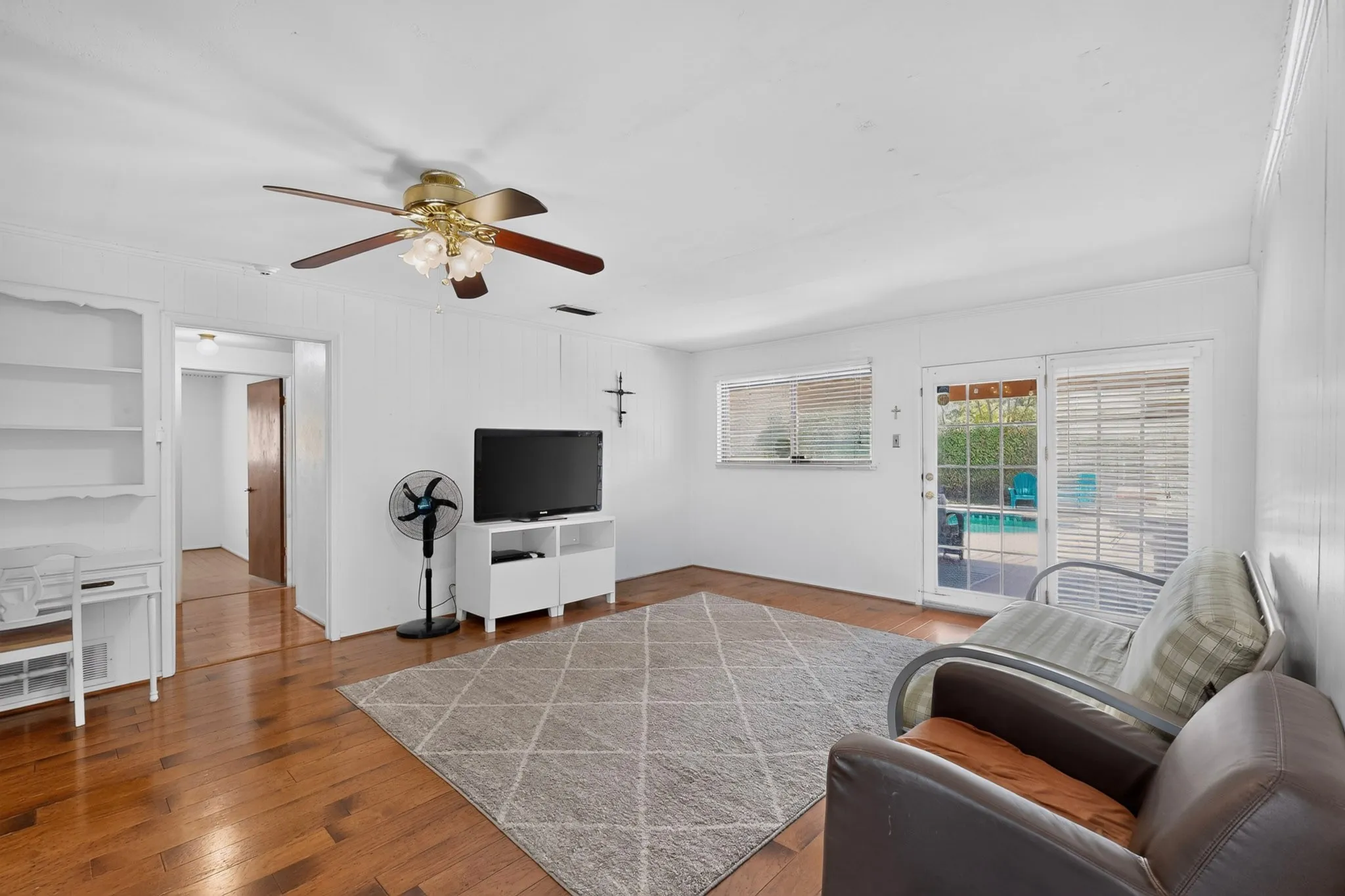 Wood-finish flooring with a ceiling fan light fixture