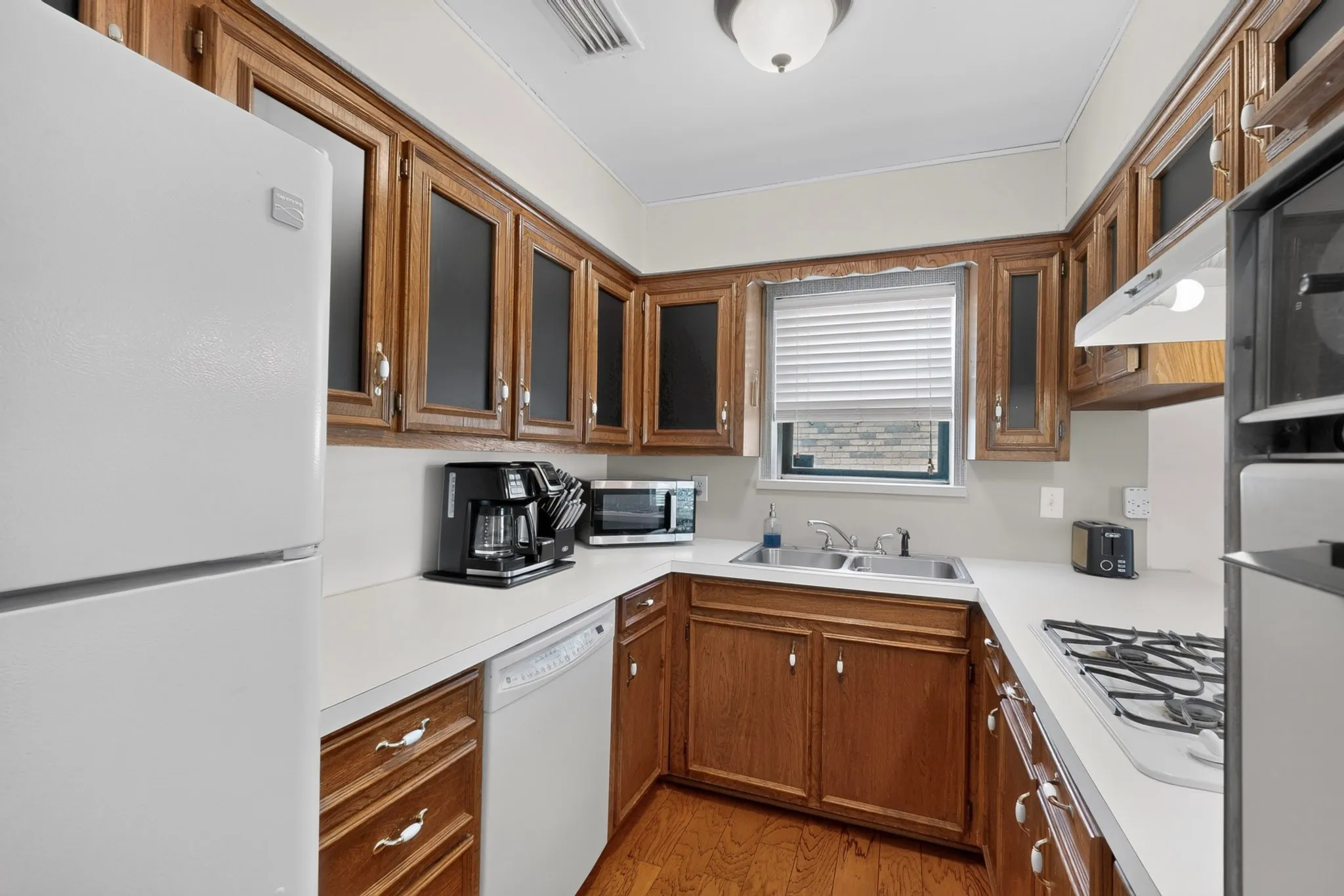 galley kitchen with double oven and gas cooktop
