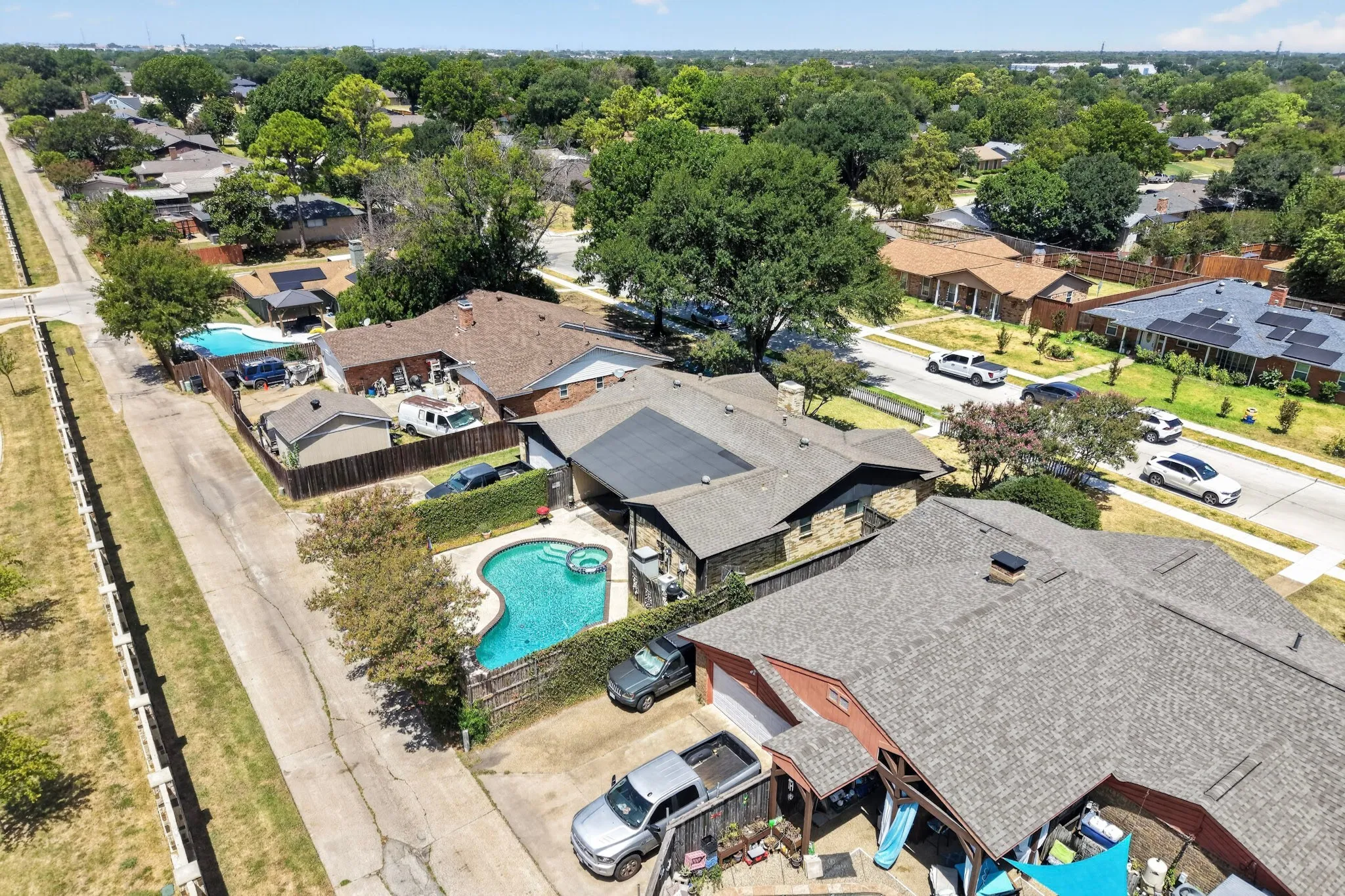 Aerial perspective highlighting a residential street with mature trees