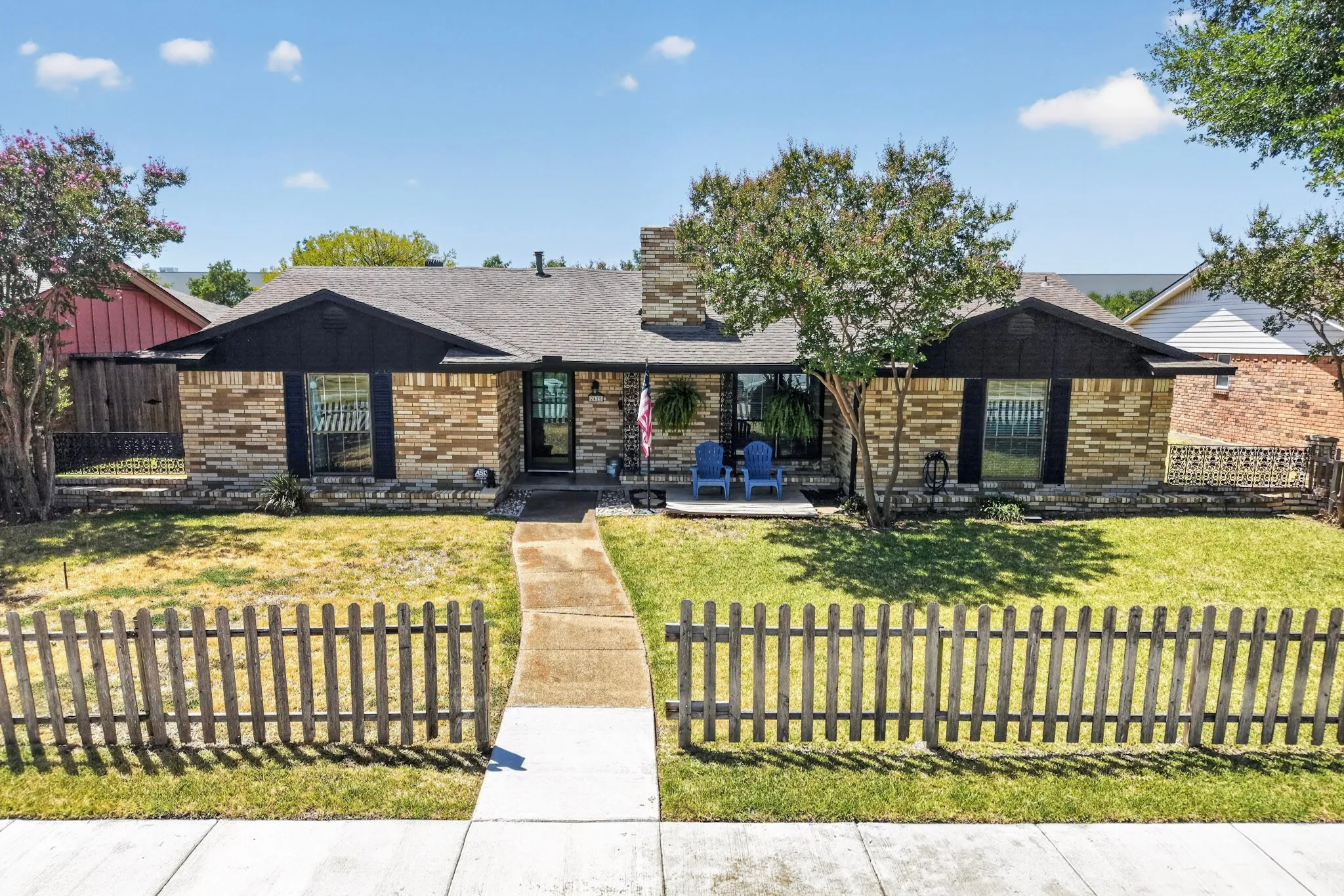 Brick exterior, picket fence, and large entry, front walkway, and fenced front yard