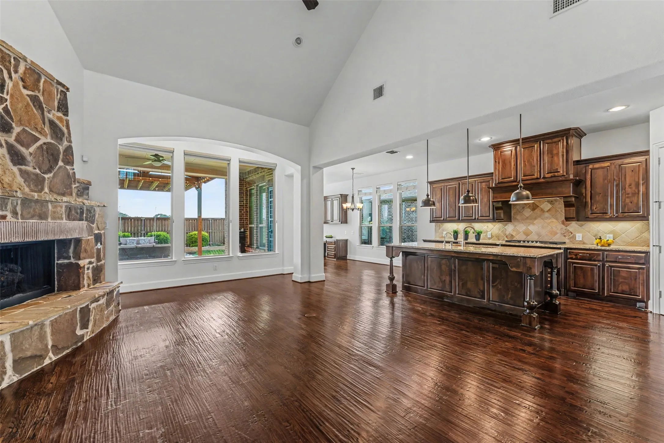Family room with wall of windows and raised hearth fireplace