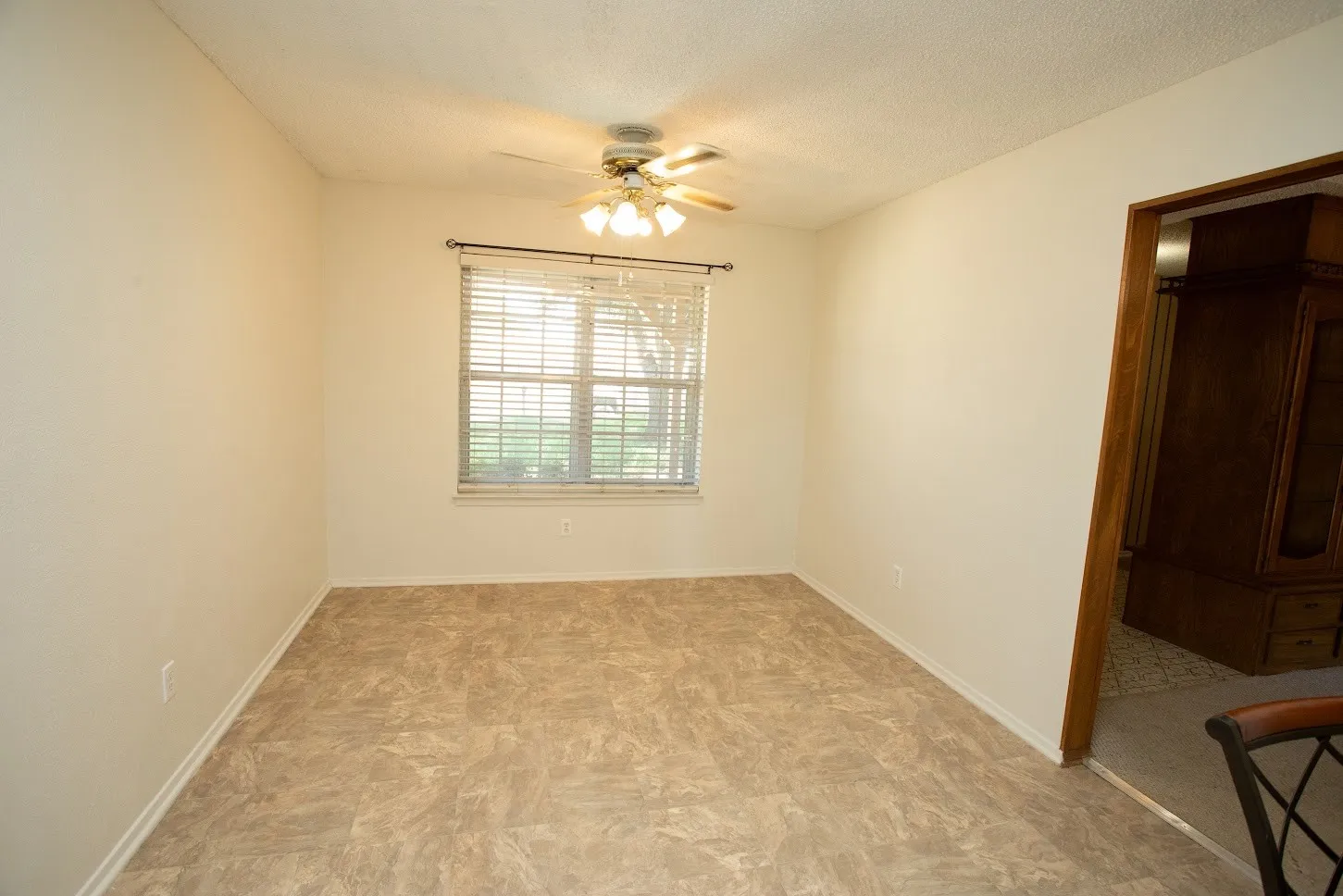 Ceiling fan and natural light in dining room.