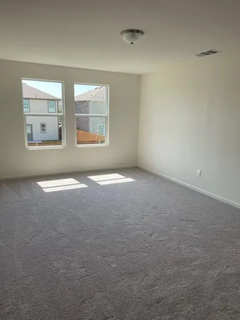 Wall-to-wall carpeting with light-colored walls, dual windows, and a flush mount ceiling light