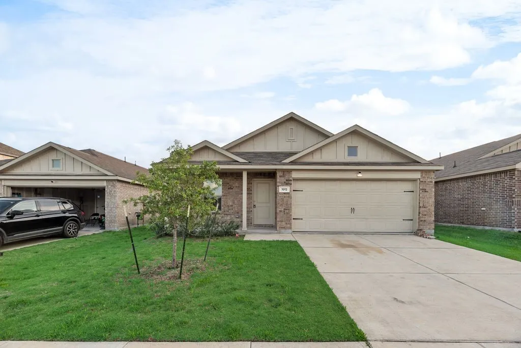 Traditional style residence featuring a brick and siding exterior
