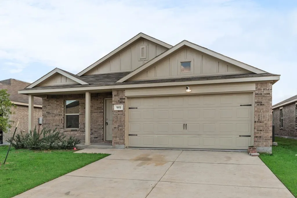 Brick exterior with light-colored siding accents and a covered front porch