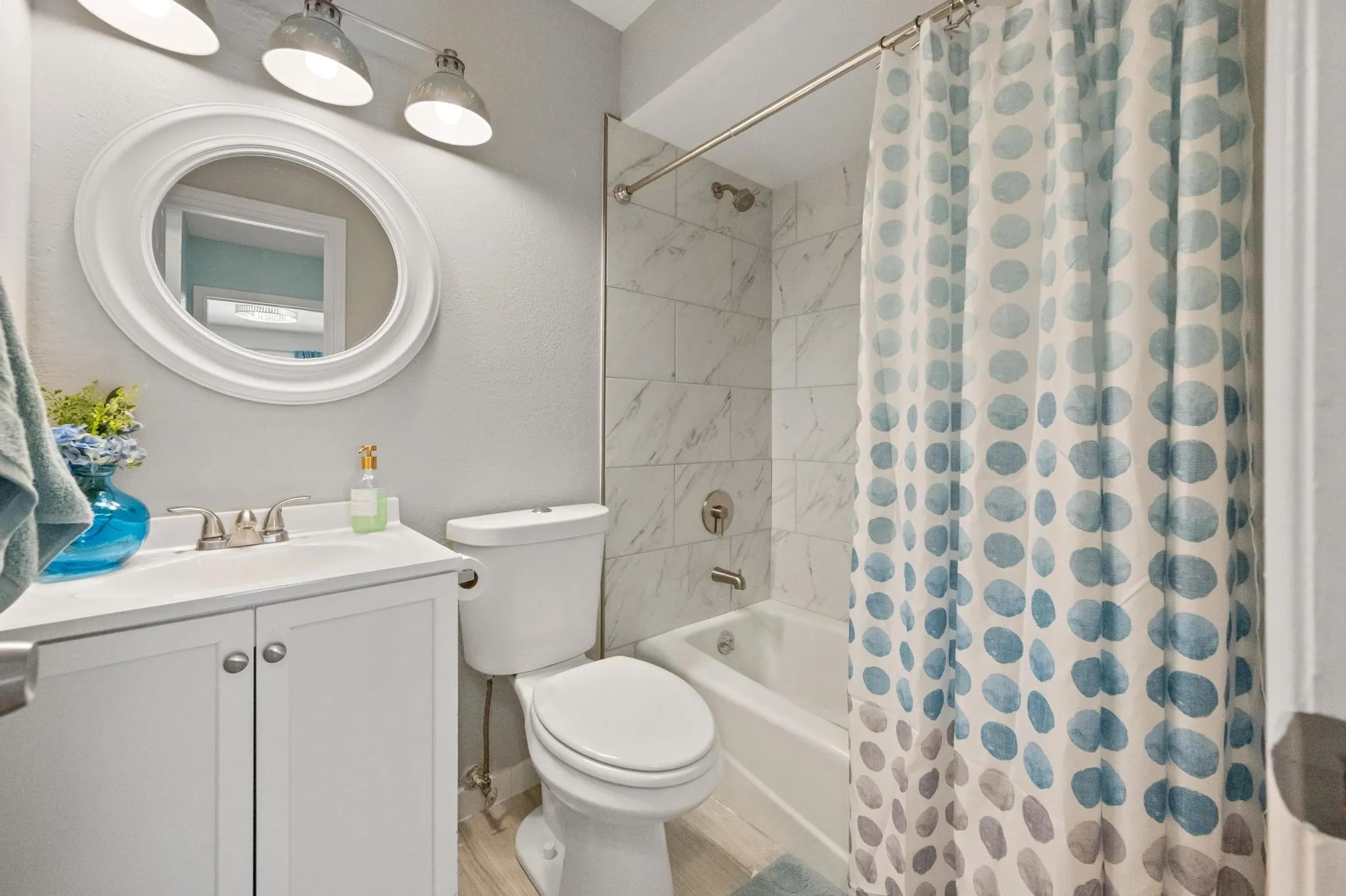 White vanity with silver-finish hardware and a white countertop