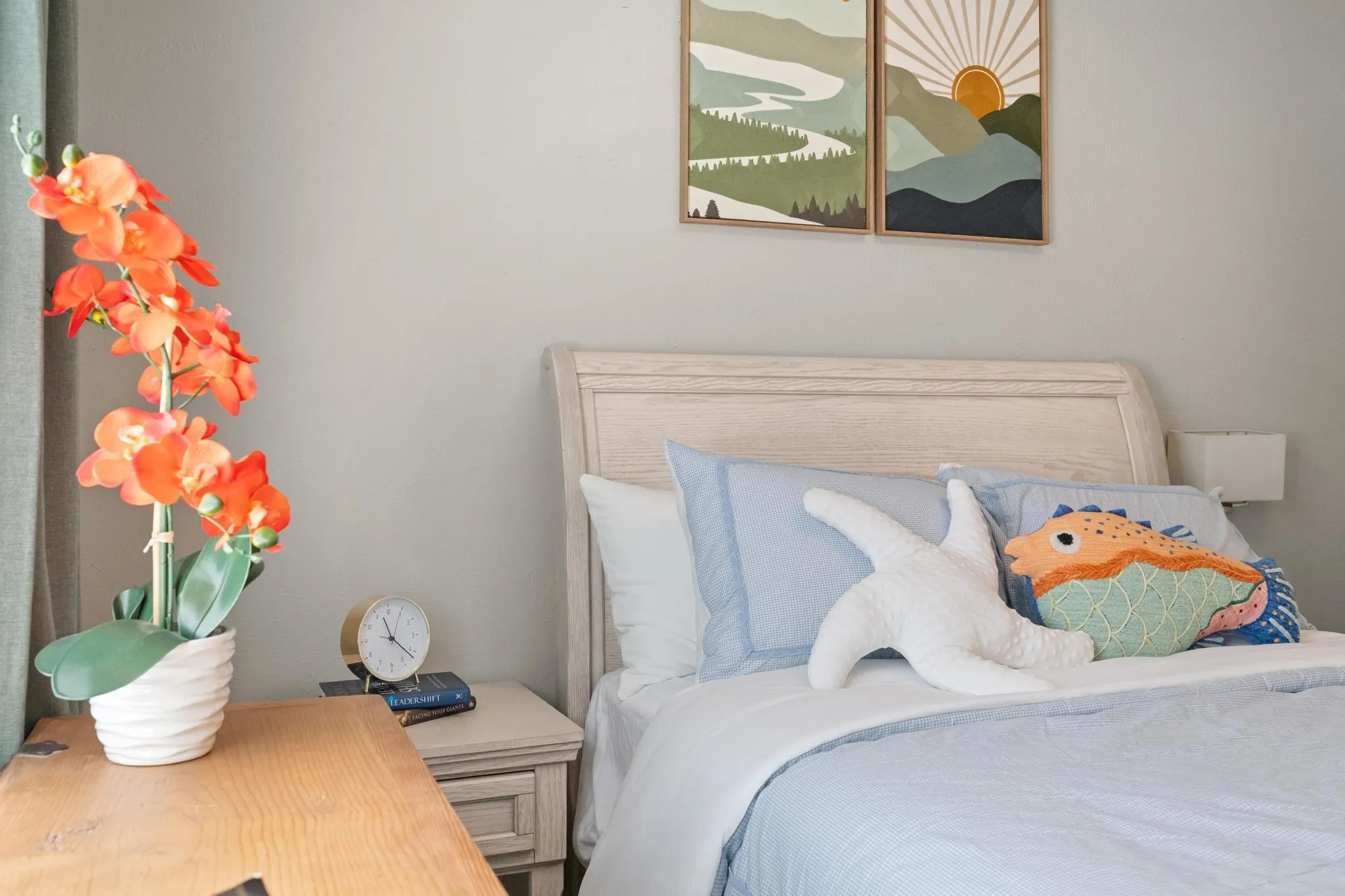 Light-toned interior wall, light wood-finish headboard, and wood-finish nightstand