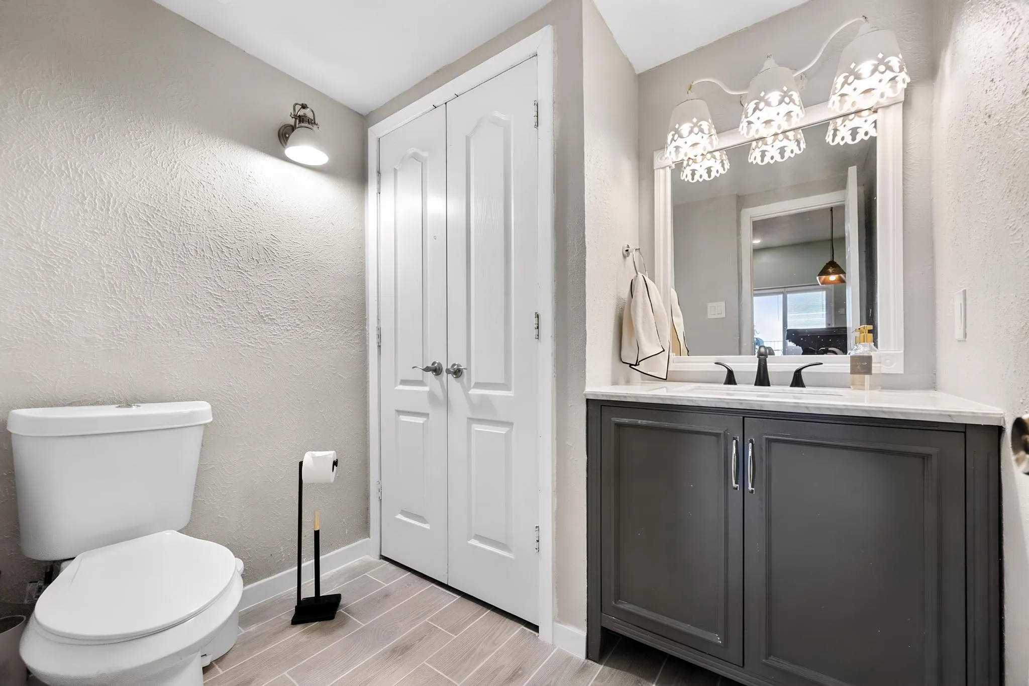 Vanity with dark cabinetry and white countertop