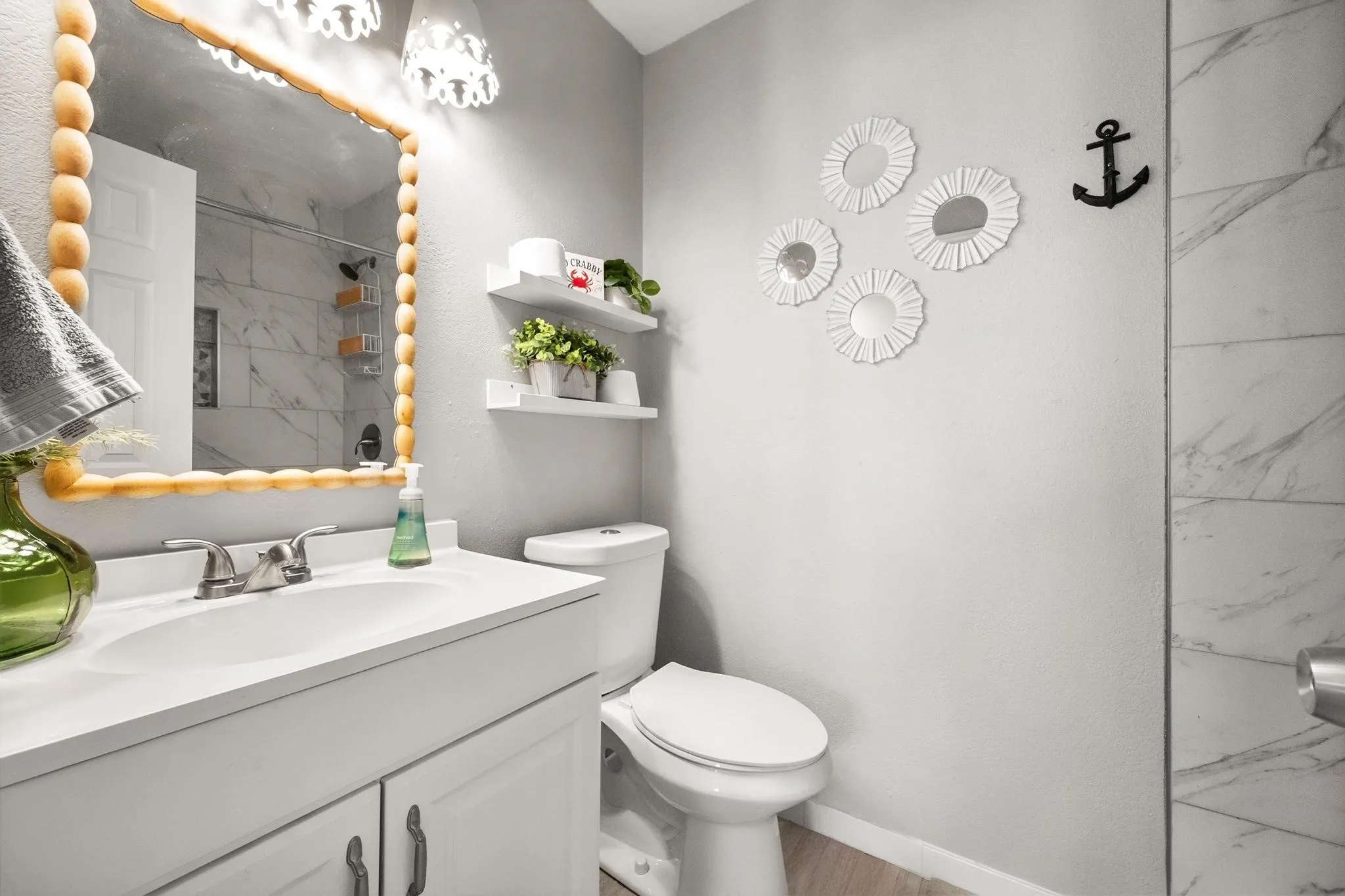 Vanity with integrated sink, dual handle faucet, and shaker-style cabinetry